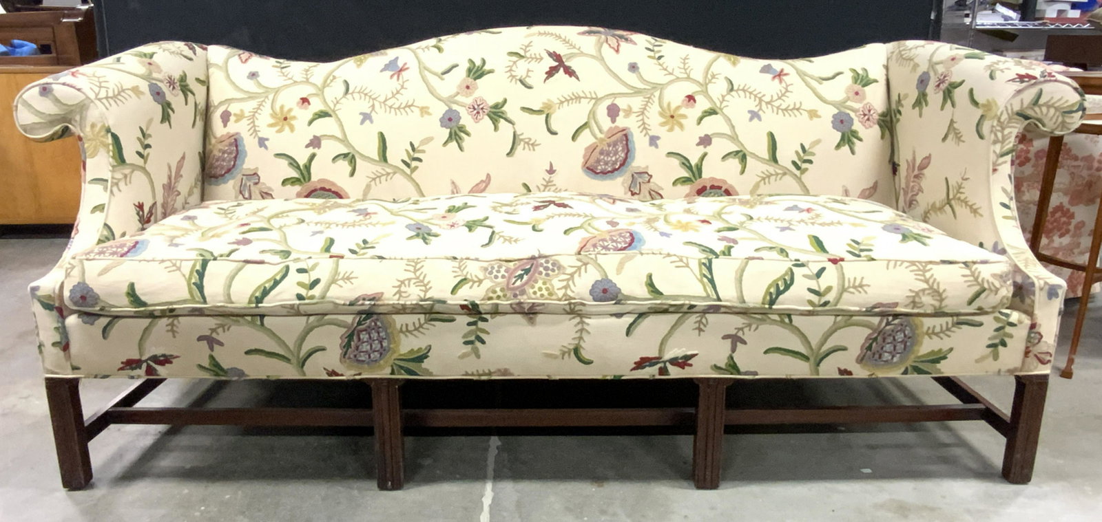 W&J SLOANE INC CREWEL Embroidered Sofa: Tag underneath cushion reads W&J SLOANE INC. Sofa is cream yellow with intricate multi toned crewel embroidery. Piece has wooden legs with stretchers in between. Piece measures approx 86 inches long 3