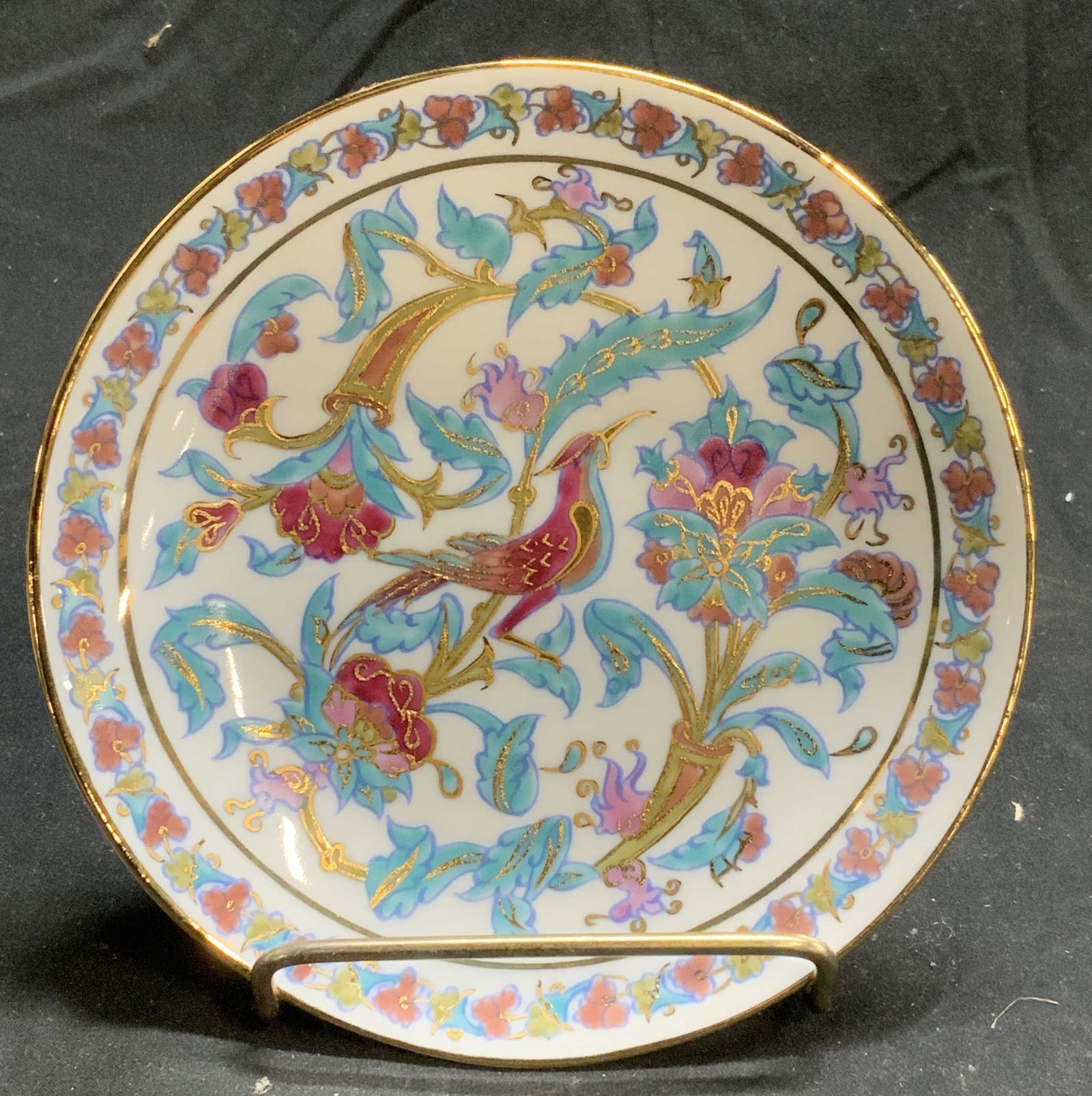 PORLAND Turkish Illuminated Porcelain Plate: PORLAND Turkish illuminated painting on porcelain plate. Floral and bird motif with gilt decoration. Trademarked to underside. Measures approx. 6 inches diameter. In good condition. PORLAND, PORLAND p