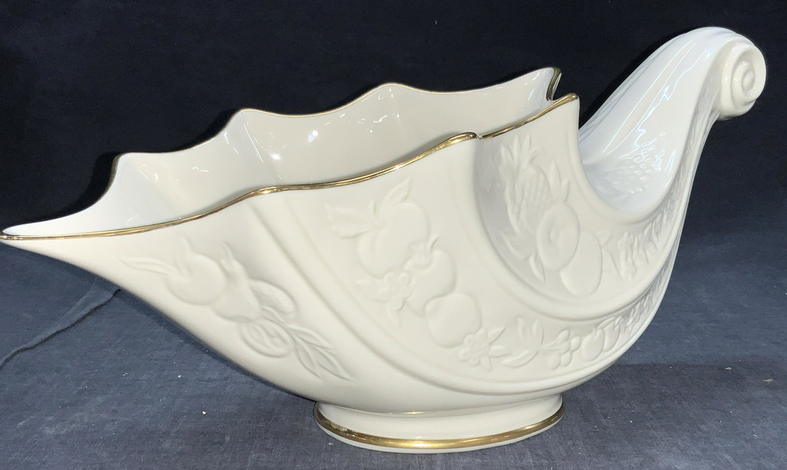 LENOX Gilt Fine China Cornucopia: Marked on underside Fruits of Life Cornucopia, Fine ivory China, Lenox. Made in u.s.a. Off white cornucopia with gilt rims and spiraled end. Exterior has raised motifs of fruits and vegetables Approxi