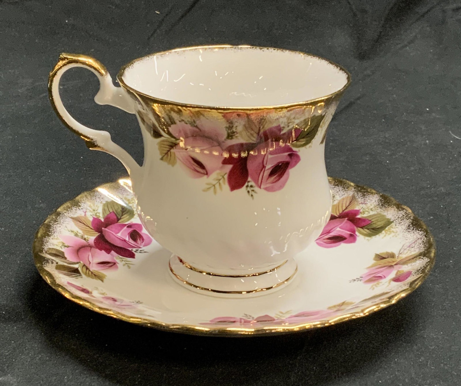 ELIZABETHAN Chinaware Floral Teacup & Saucer: Elizabethan fine bone china teacup and saucer with floral pattern and gilt decoration. Cup measures approx. 3 inches diameter and 3 inches tall. Saucer measures approx. 5.75 inches diameter. Pieces tr