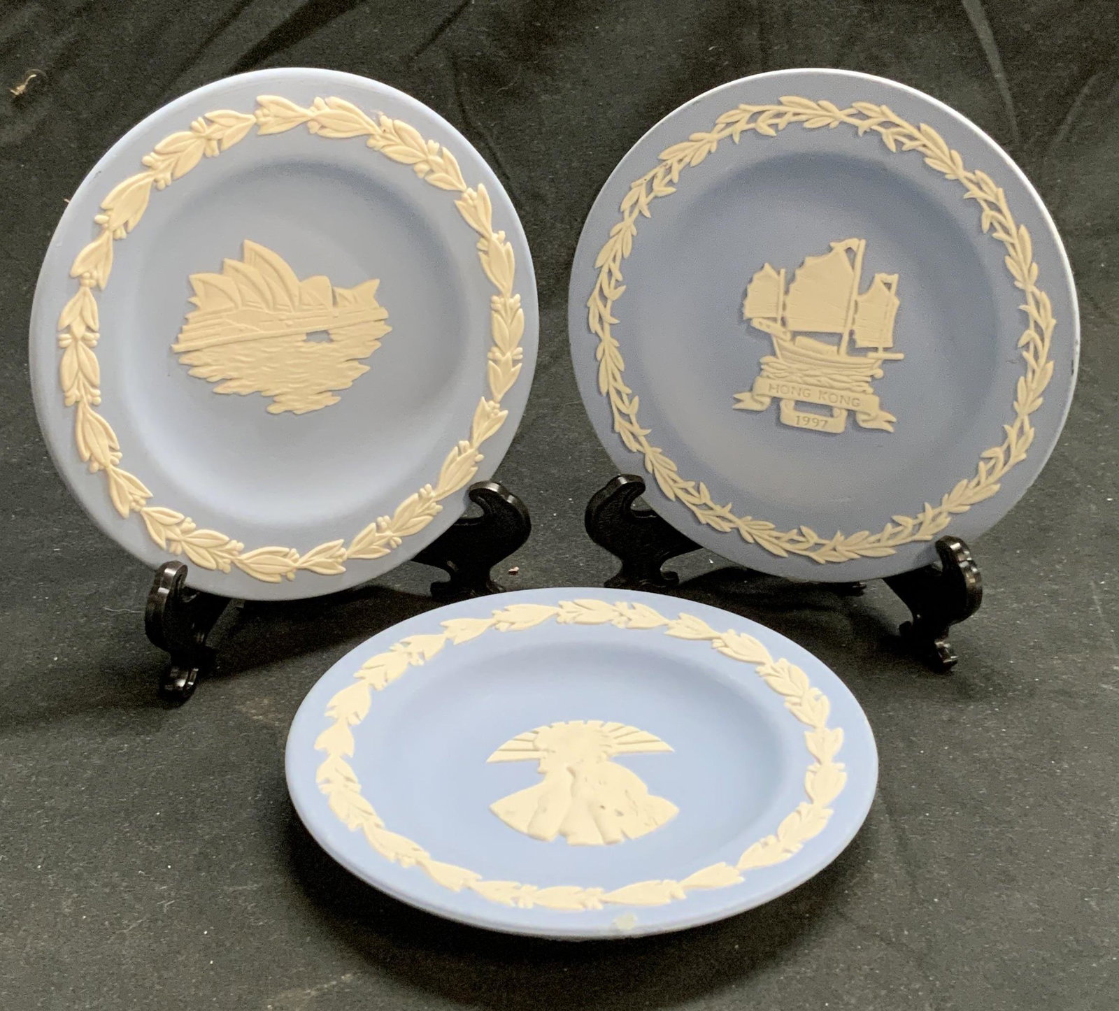 Lot3 WEDGWOOD Blue Jasperware Collectors plates: Group of 3 Wedgwood light blue Jasperware collectors plates plates. All pieces trademarked to undersides. All pieces in good condition with some surface wear consistent with exposure. Includes 1997 Ho