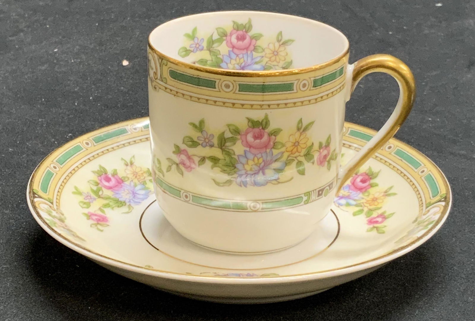 NORITAKE Alicia Porcelain Demitasse & Saucer: NORITAKE Alicia pattern porcelain demitasse cup and saucer with floral and gilt decoration. Trademarked to undersides. Demitasse measures approx. 2 inches diameter and 2 inches tall. Saucer measures a