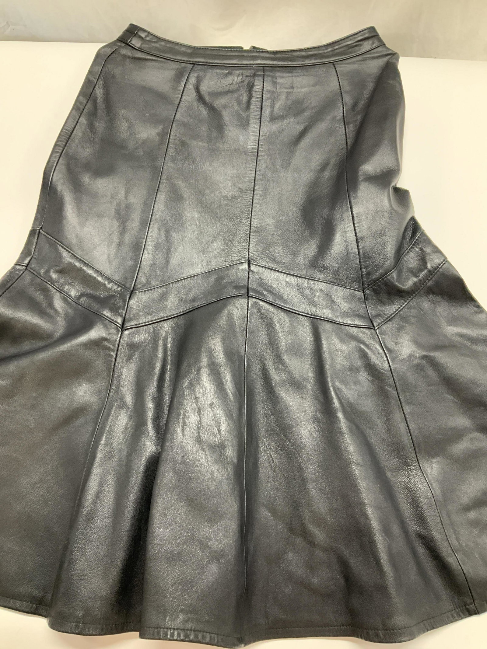 Rome Voice Leathers Black Leather Skirt: Vintage size 46, genuine leather skit with flared ruffle body. 28.5 in long. Waist 28-29 in. Snap and zipper back. Nylon lining. Vintage wear, Estate wear, Brooklyn vintage chic fashion, skirt, Leathe