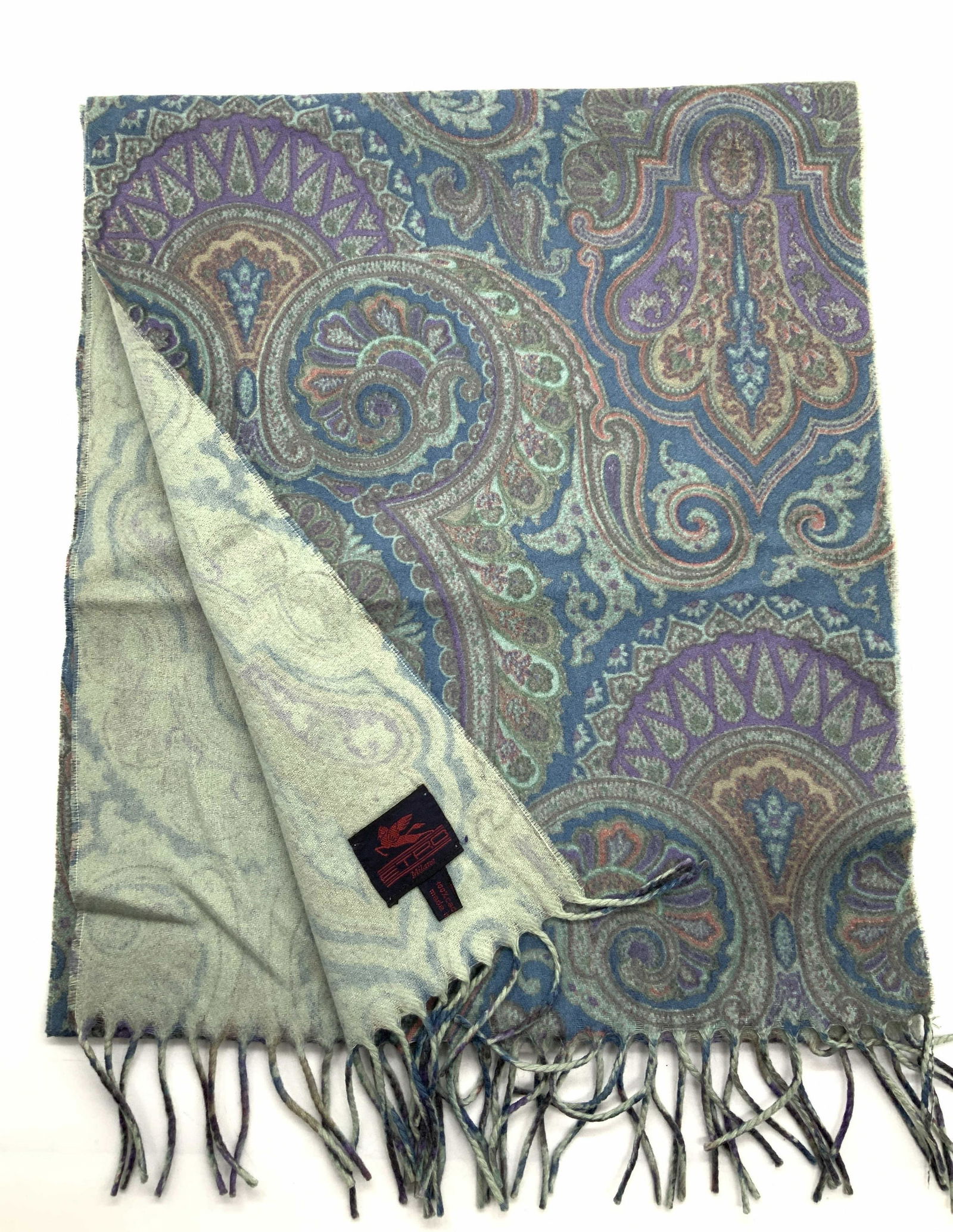 ETRO 100% Cashmere Blue Paisley Fringe Scarf: Label reads ETRO, 100% Cashmere, Made in Italy. Scarf is adorn with Paisley patterns in cool tones of blues, purples and greens with fringe ends. Approximately 40 inches long and 13.25 inches wide. ET