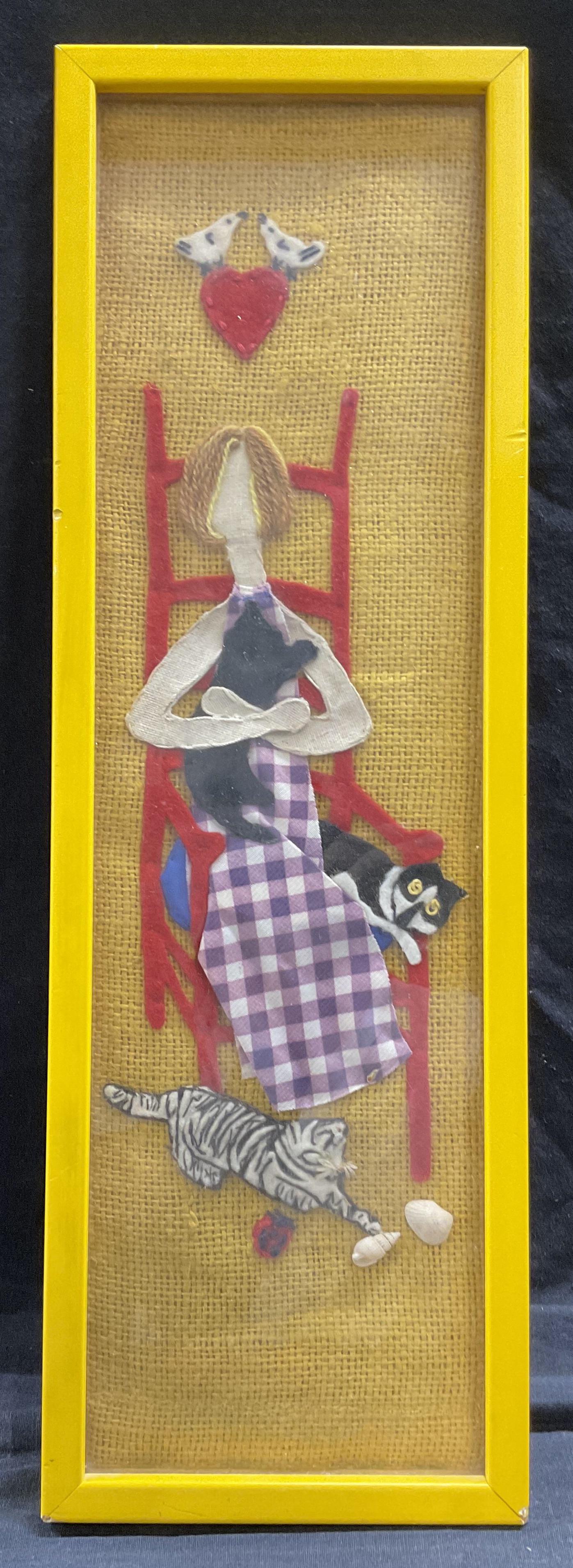 Textile Artwork of Woman with Cats: Textile Artwork of Woman with Cats, no apparent inscriptions or signatures, subject a woman seated in a chair with cats, measures 19 1/8 x 6 1/4 inches, yellow wooden frame, surface wear to frame, pro