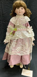 EDNA HIBEL Porcelain Katie Doll: Grandmas Attic by Edna HIBEL porcelain Katie doll. Trademarked to tag. Measures approx. 19 inches long. In good condition. Grandmas attic, Edna HIBEL, Edna HIBEL doll, display doll, porcelain doll, co