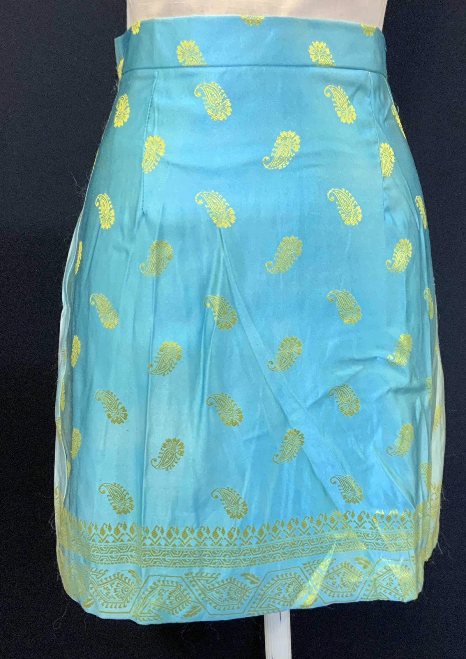 Vintage Blue & Green Paisley Mini Skirt: Vintage Blue and green paisley mini skirt. Measures approx. 12.75 inches across waist. Polyester and nylon blend. Fabric has no stretch. Some fading to fabric. Mini skirt, blue skirt, paisley skirt, l