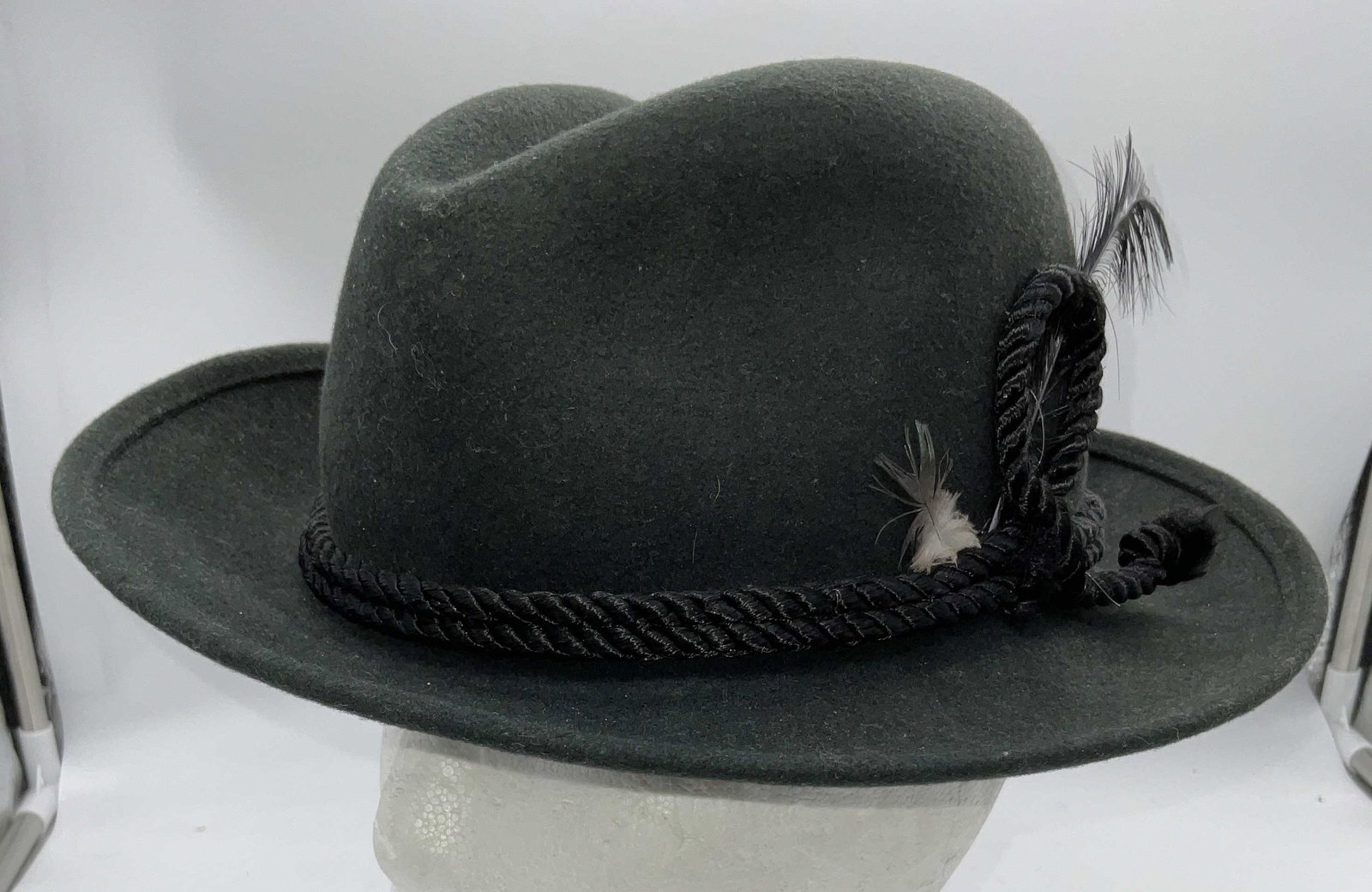USA Made Green Felt Fedora W Band: USA Made Green Felt Fedora W Band. Rope band to piece with feathers, label to inside reads Small Made in USA Small. Interior measures 7 3/4 in by 6 in. Brim measures 12 in by 11 in. No visible name la