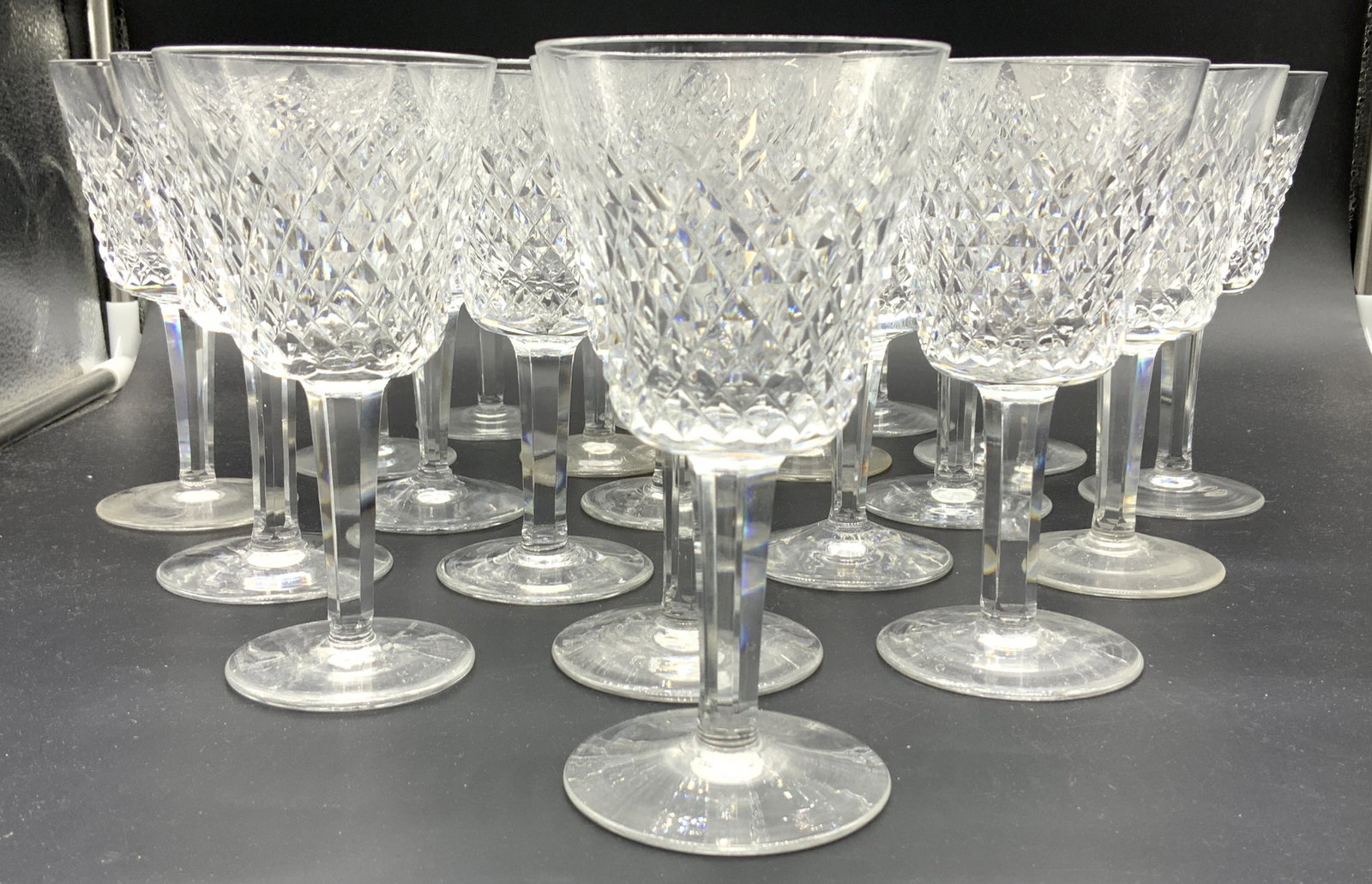 WATERFORD Alana Crystal Vintage Stemware, 20: VintageWaterford Alana Crystal Stemware, diamond cut, 20 total, 6 in ht, 3 in. Wide. 3 that have rim chip or side chip on goblet. Hand formed and hand cut vintage crystal. A couple still have acid Wat
