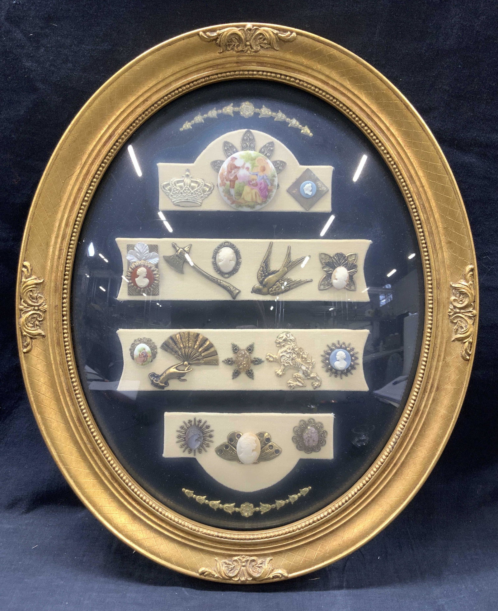 Framed Antique Sterling & Porcelain Brooches: Framed sterling silver and painted porcelain antique brooches consisting of embossed and etched sterling brooches of birds, axes, asian inspired fans. Hand painted brooches at 1.5 inches wide and vari