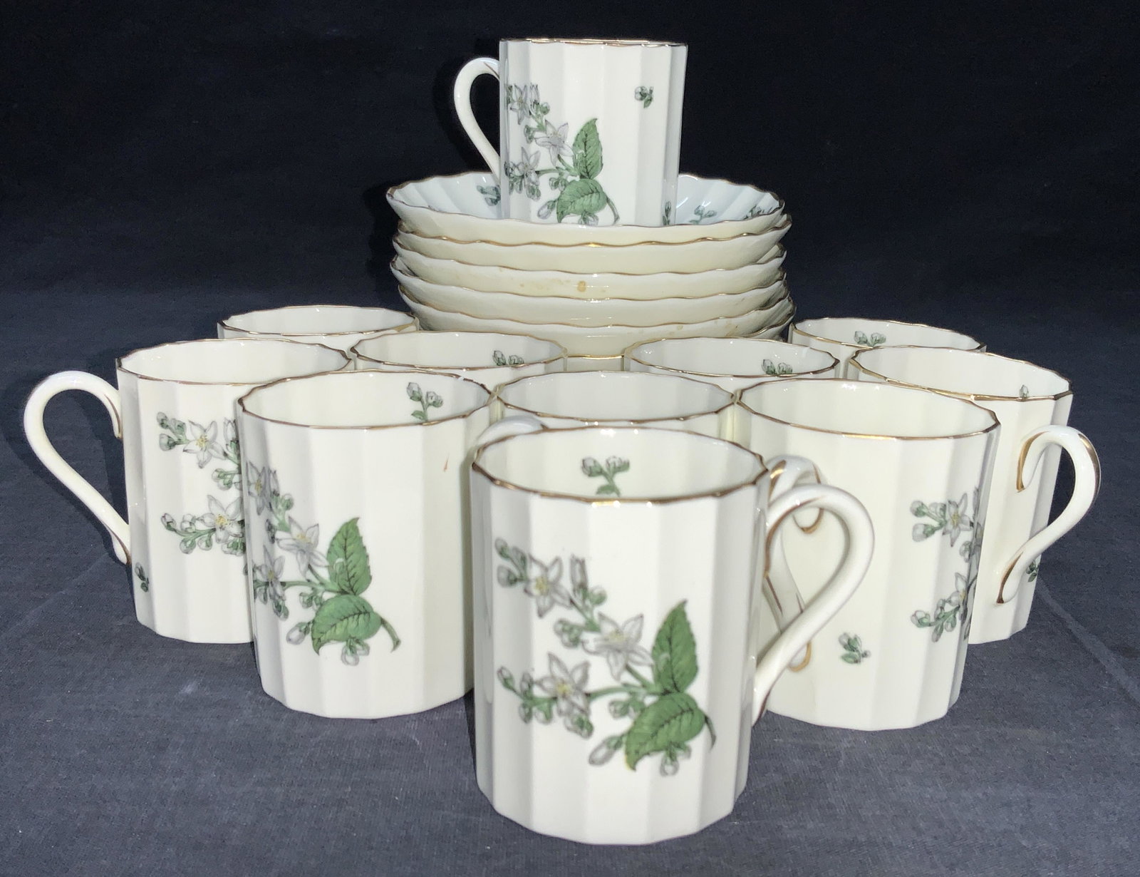 23 ROYAL WORCESTER Bone China Cups & Saucers: Set 23 ROYAL Worcester bone china, made in England, Valencia pattern. 11 demitasse cups and 12 Saucers. Demitasses approximately 2.25 inches tall and saucers are approximately 4.25 inch diameter. Gilt