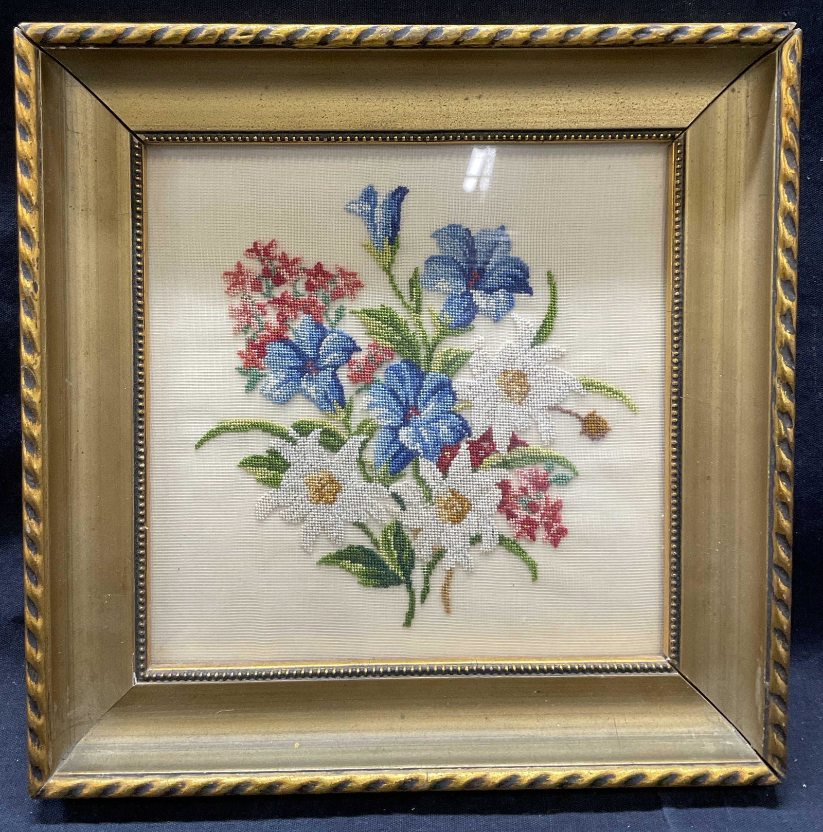 Framed Embroidered Floral Bouquet: Framed Embroidered Floral Bouquet. Whole measures approx 8.5 x 8.5 inches, window measures 6 x 6 inches. Framed in a gilt frame, embroidery behind glass. Significant wearing to surface of frame, (see 