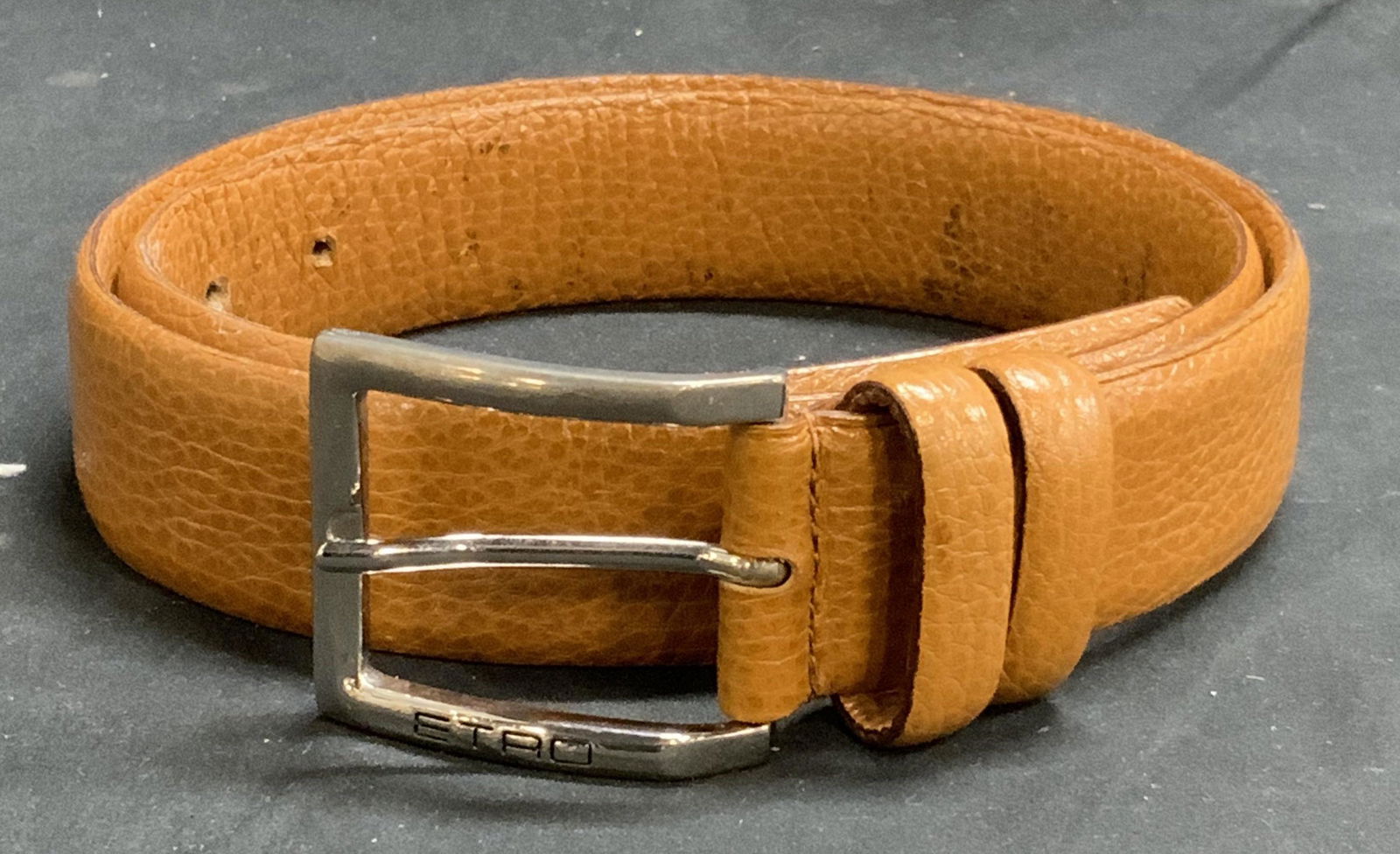 ETRO Tan Leather Belt, Luxury Menswear, Italy: ETRO tan leather belt. Designer label to interior. Measures approx. 40 inches long. Wear to leather consistent with exposure. Made in Italy. ETRO, ETRO belt, luxury menswear, mens luxury belt, mens lu