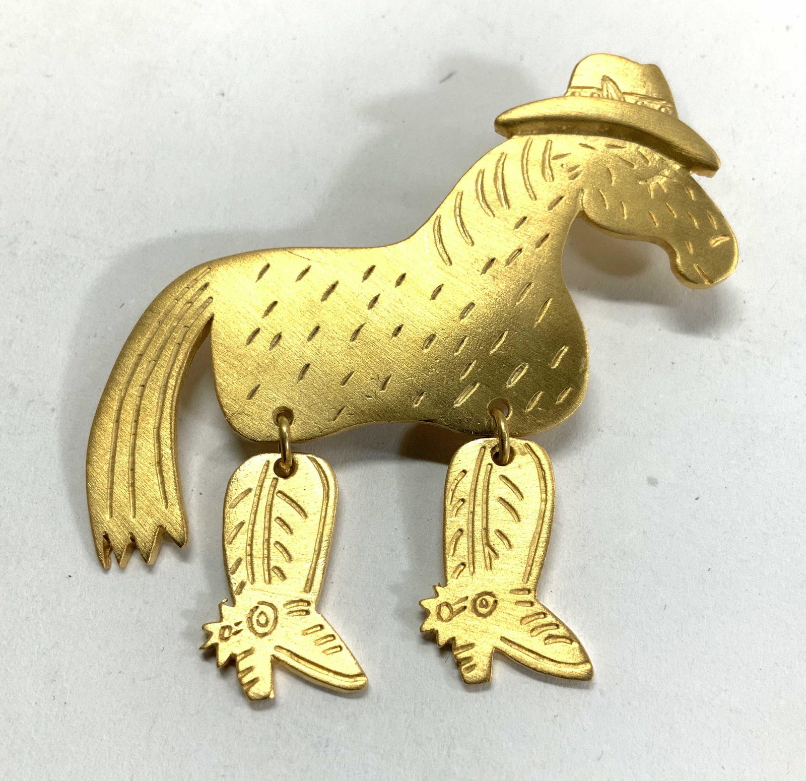 JJ Brushed Gold Tone Cowboy Horse Brooch: Etched gold tone horse brooch with Articulated cowboy boots. Measures 2.5 x 2.5 in. Signed JJ. Articulated Horse brooch, horse ranch jewelry, Gold-tone horse Brooch, equine jewelry, Luxury Articulated