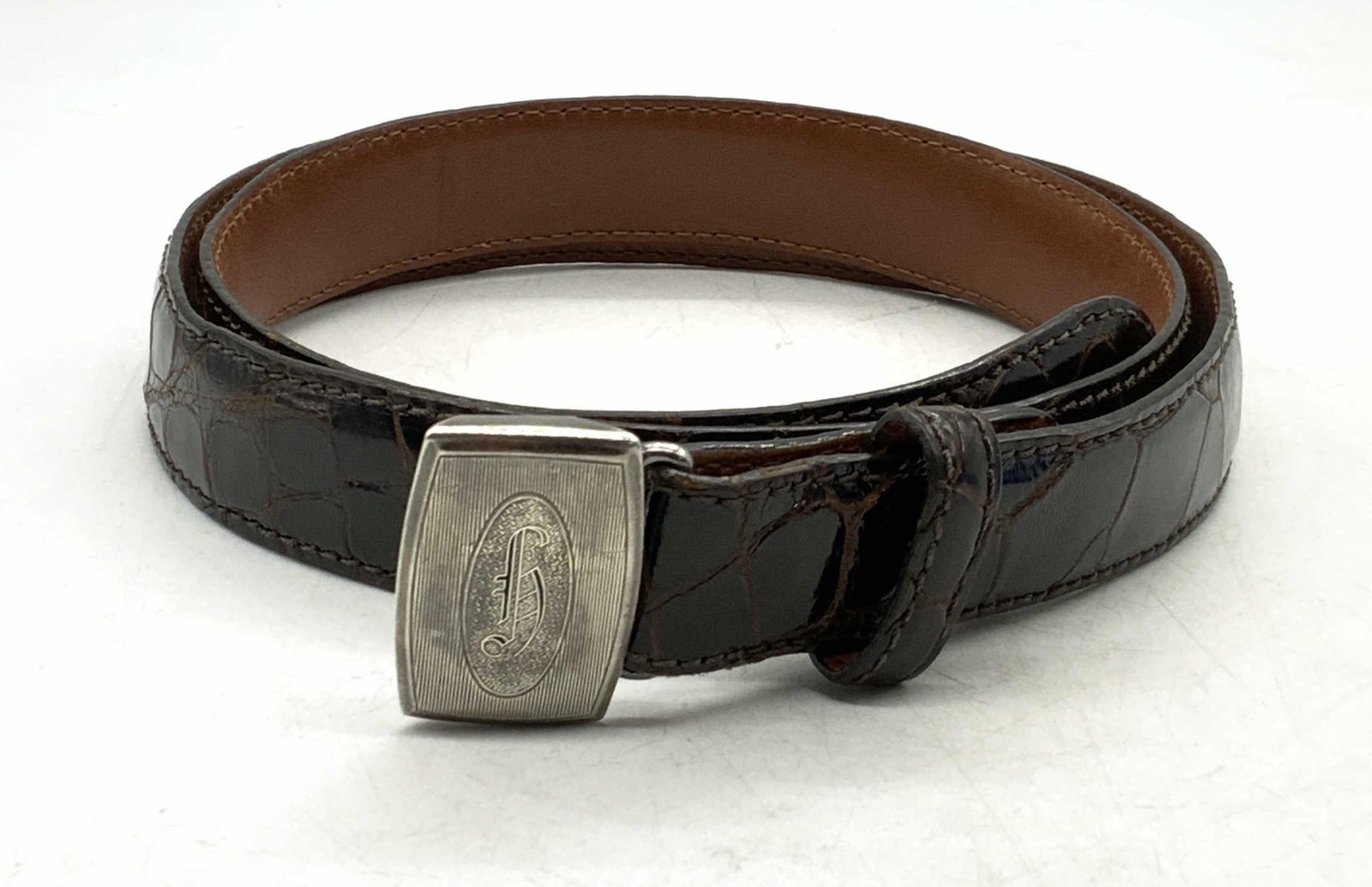 HIGKOK Sterling Silver Buckle & RALPH LAUREN Belt: HIGKOK sterling silver belt buckle and Ralph Lauren brown alligator leather belt. Belt size 32. Designer label to interior. Buckle measures approx 1.5 x 1 inches. Total weight of buckle .68 ozt. Marke