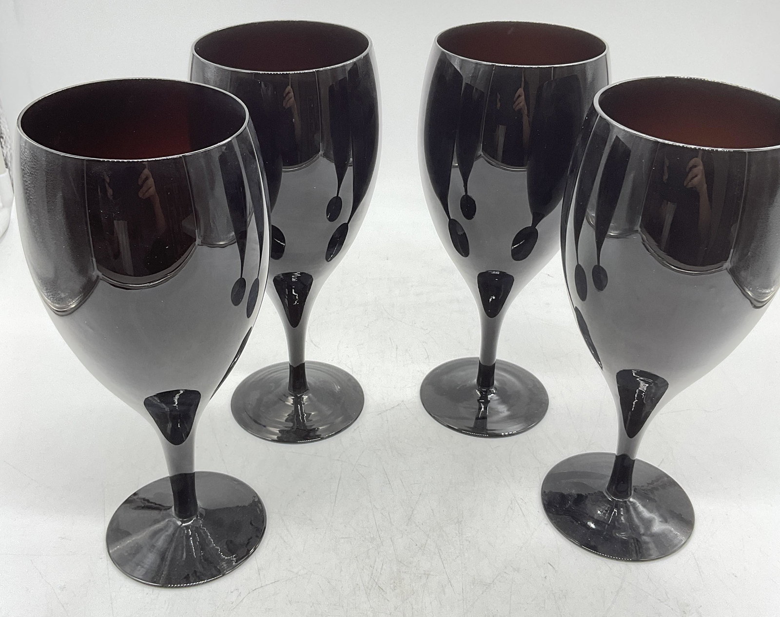 Set 4 Black Amethyst Handblown Kitchen Glasses: Set 4 Black Amethyst Handblown Kitchen Glasses. Measures approx 8.25 x 3.5 inches. No visible cracks, no visible name label to pieces. Pontil to base. Glass ware, dark hand blown glass, hand blown gla