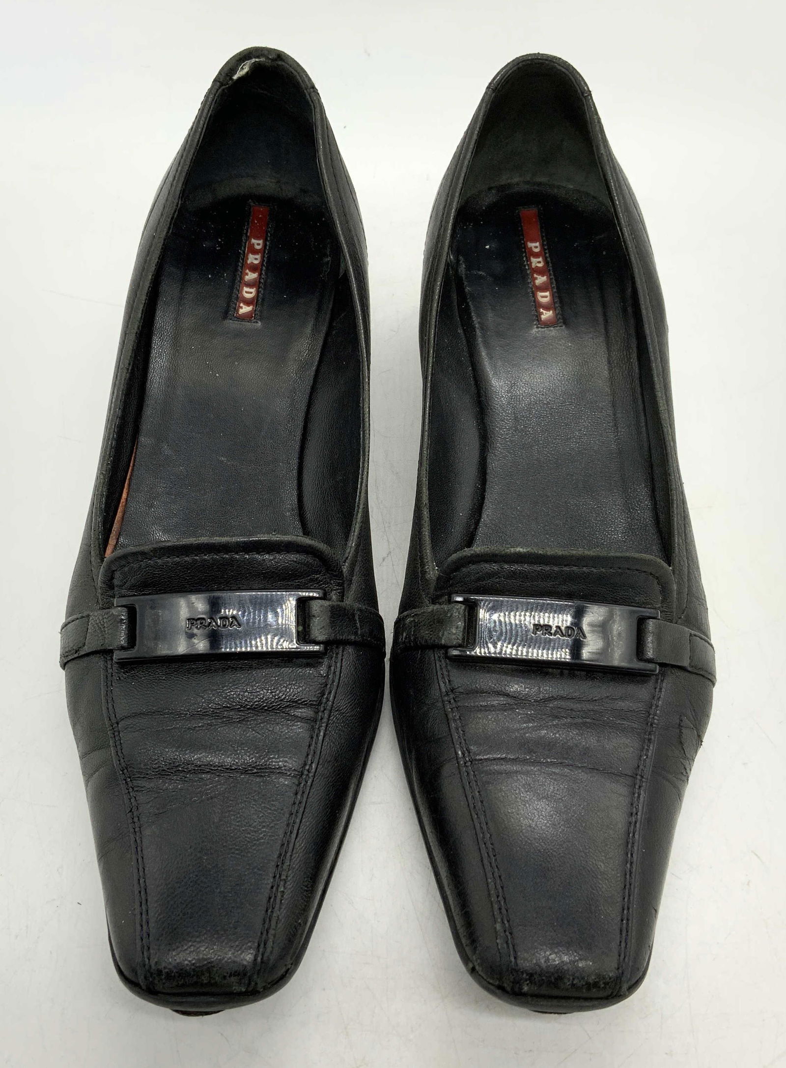 PRADA Black Leather Kitten Heels: Prada black leather kitten heels. Size 38.5. Heel height approx. 1 inch. Designer label to soles. Wear to leather and soles consistent with exposure, need repair to soles. Prada, Prada heels, Prada ac