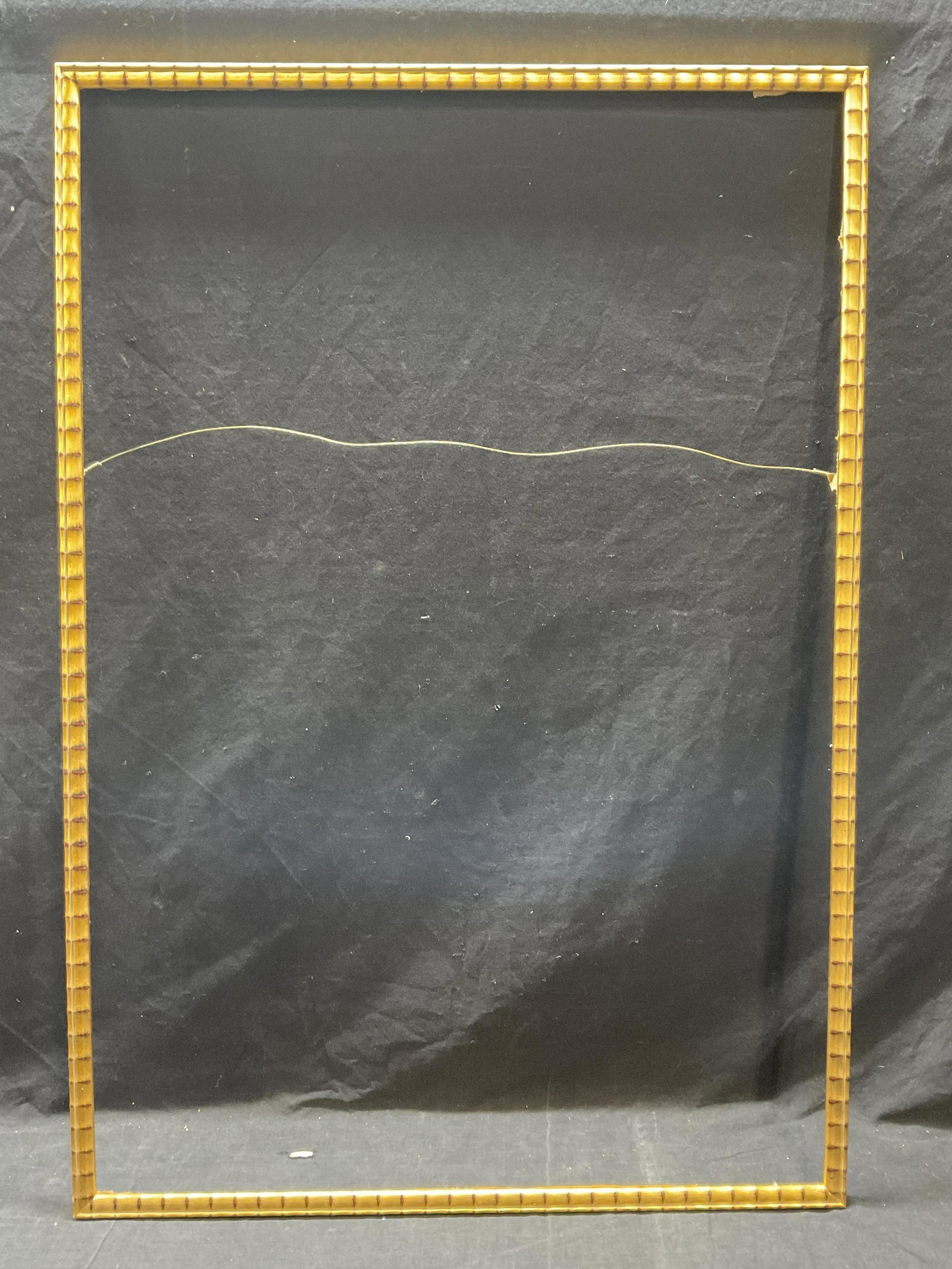 Wooden Gilt Frame: Wooden gilt frame. Outside measurement 27.75 x 40.25 inside measurement is 26.5 x 39 inches. Typical wear to piece consistent with prior use. Wire to frame. Wooden frame, gilt wooden frame, home decor