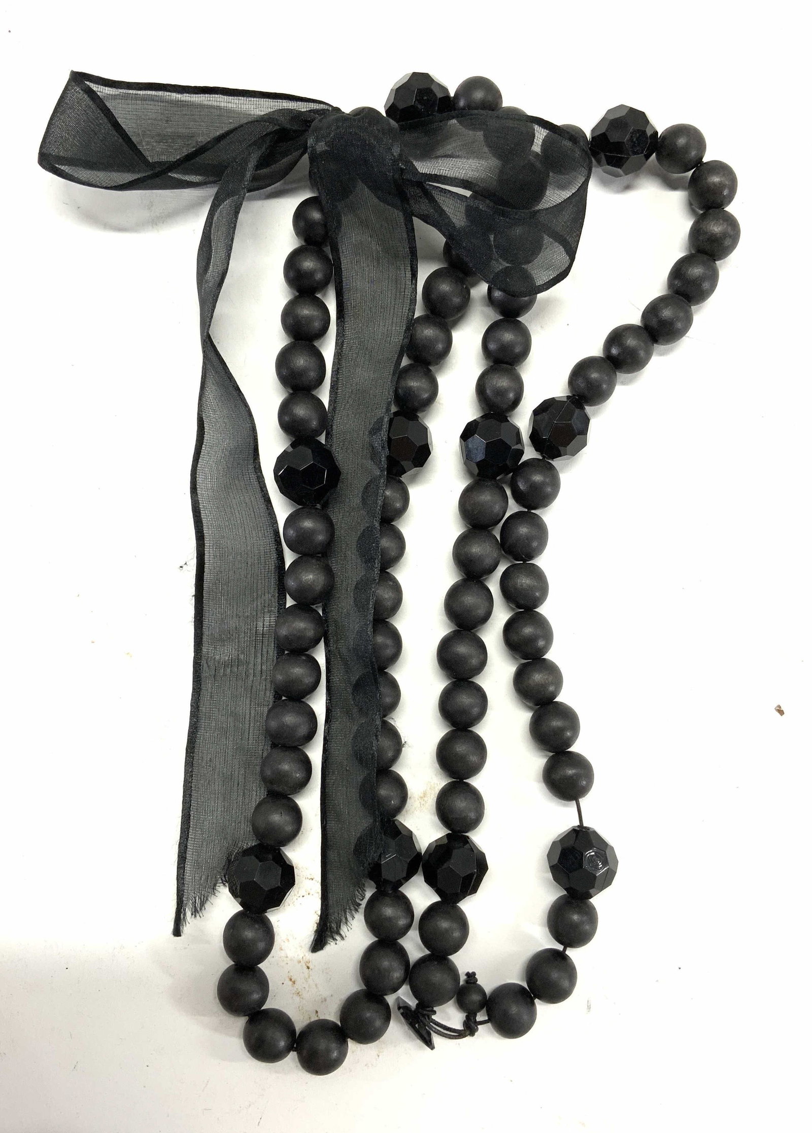 Chunky Black Beaded Bow Necklace: Chunky black beaded bow necklace. Black composite acrylic beads with bow ribbon decoration measures approx. 50 inches long. In good condition. Property of Manhattan, New York estate. Estate jewelry, f