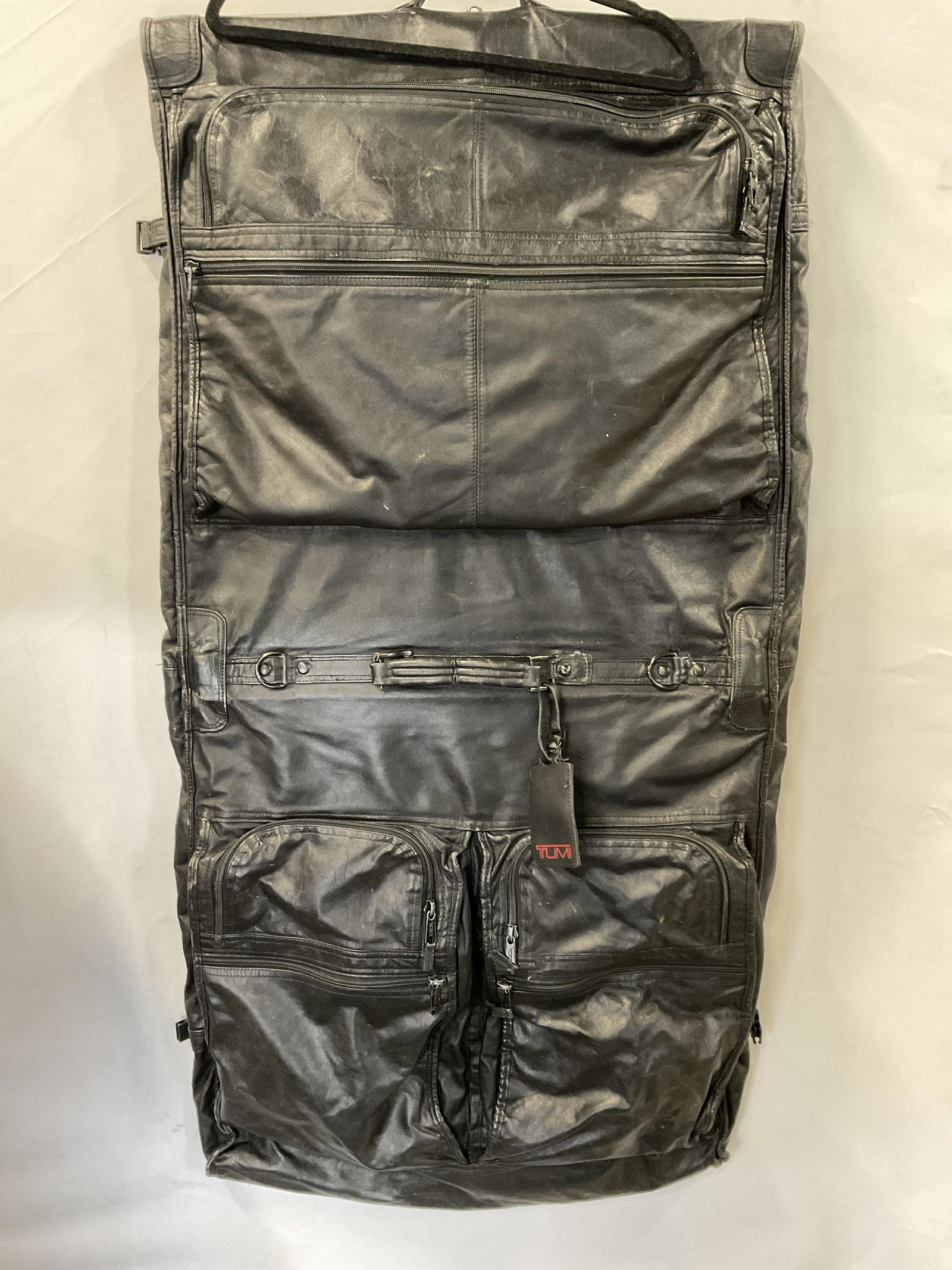 TUMI XL Leather Luggage: TUMI XL Leather Luggage Significant wear to piece consistent with prior use and age. When luggage is OPEN IT Measures approx 47 X 27.5 inches. Multiple pockets to luggage. TUMI luggage, leather TUMI l
