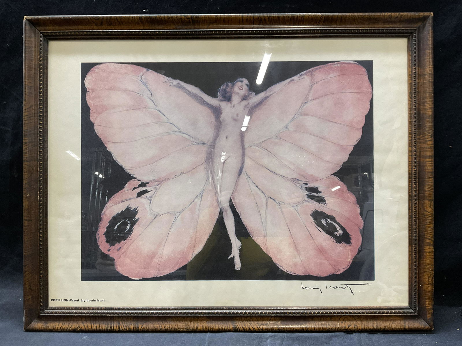 Papillon, Louis Icart Framed Lithograph: Papillon, Louis Icart Framed Lithograph. Framed in a wooden frame with detailed inner edge, behind glass. Font to lower left reads ‘PAPILLION - Fromt by Louis Icart’. Window within frame measures