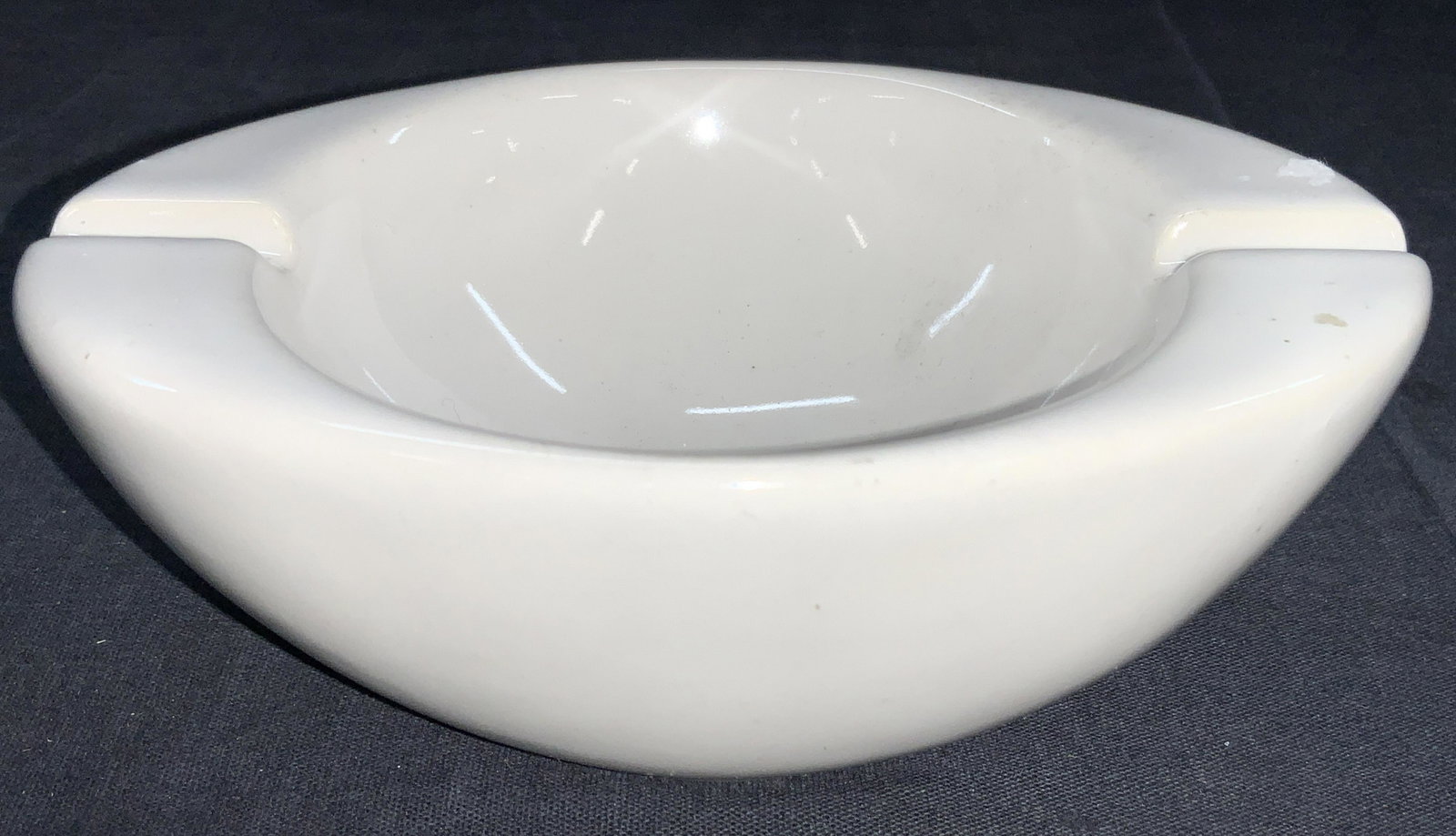 Minimalist Style Ceramic Ashtray / Vessel: Minimalist style white ceramic ashtray bowl with indents on sides for cigarettes. Approximately 2 inches tall and 6 inch diameter. Evident wearing due to age and use. Ceramic ashtray, ashtray, home de