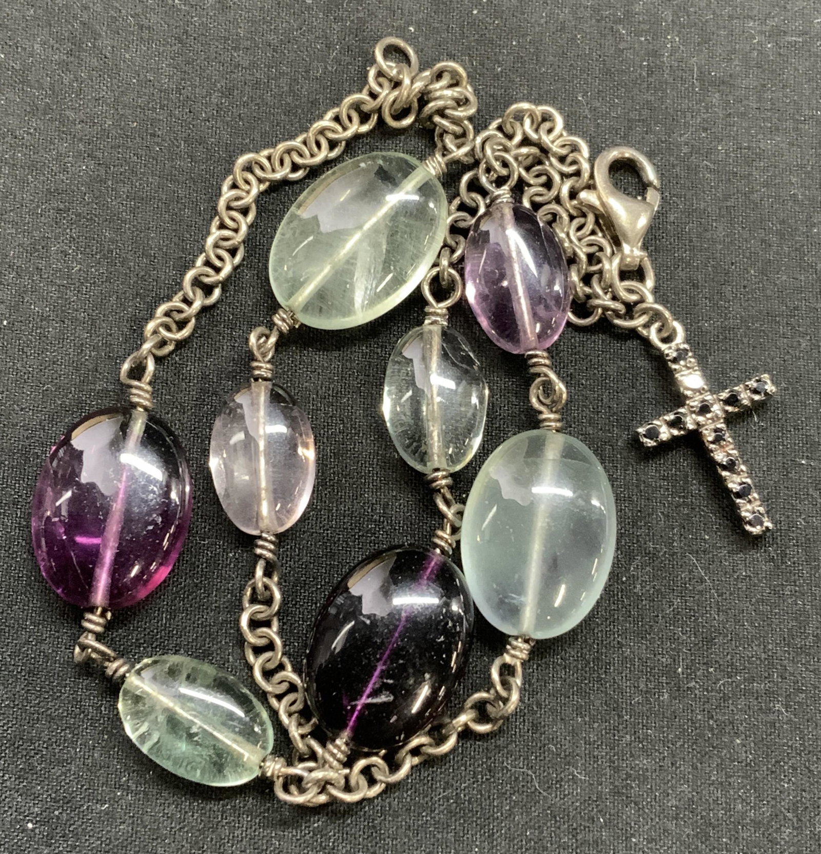 Purple & blue Beaded Bracelet w Cross Charm: Purple and blue beaded Cabochon bracelet with black bejeweled cross charm. Measures approx. 7 inches long. Some surface wear consistent with exposure. Beaded bracelet, blue bracelet, purple bracelet, 