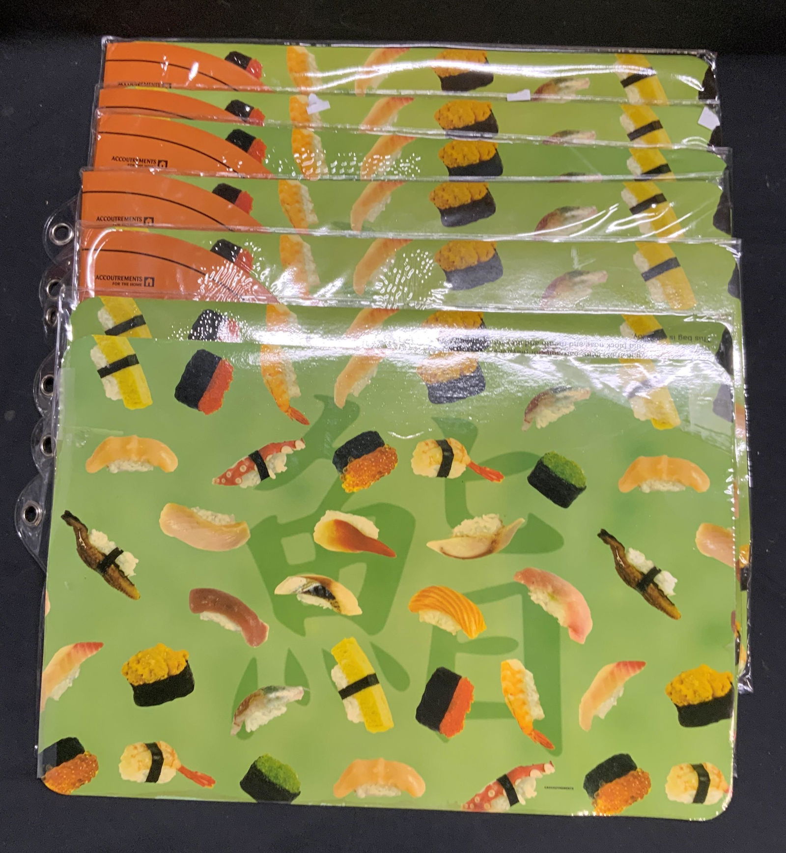 Set 12 Accoutrements Sushi Placements, NIP: Set of 5 Accoutrements sushi placemats. Each set contains 2 pieces. 2 pieces separated. 12 pieces total. 5 sets new in original packages. Not examined outside of packages. 2 placemats removed from ori
