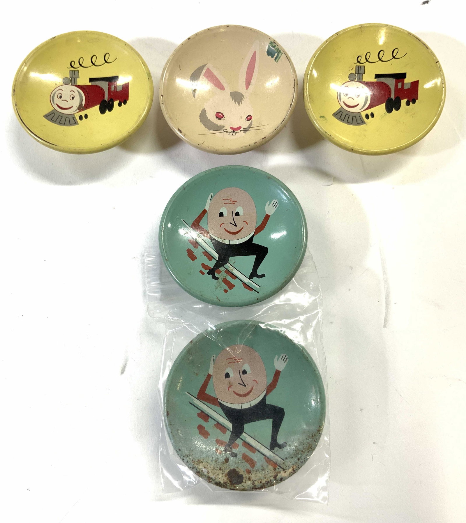 Lot 5 Vintage Metal Drawer Pulls: Lot includes 5 drawer pull. 2 Humpty Dumpty, 2 steam engines with happy faces & 1 rabbit. Each measures approx 2.5 inches diameter. Drawer pulls, vintage drawer pulls, metal drawer pulls, vintage meta