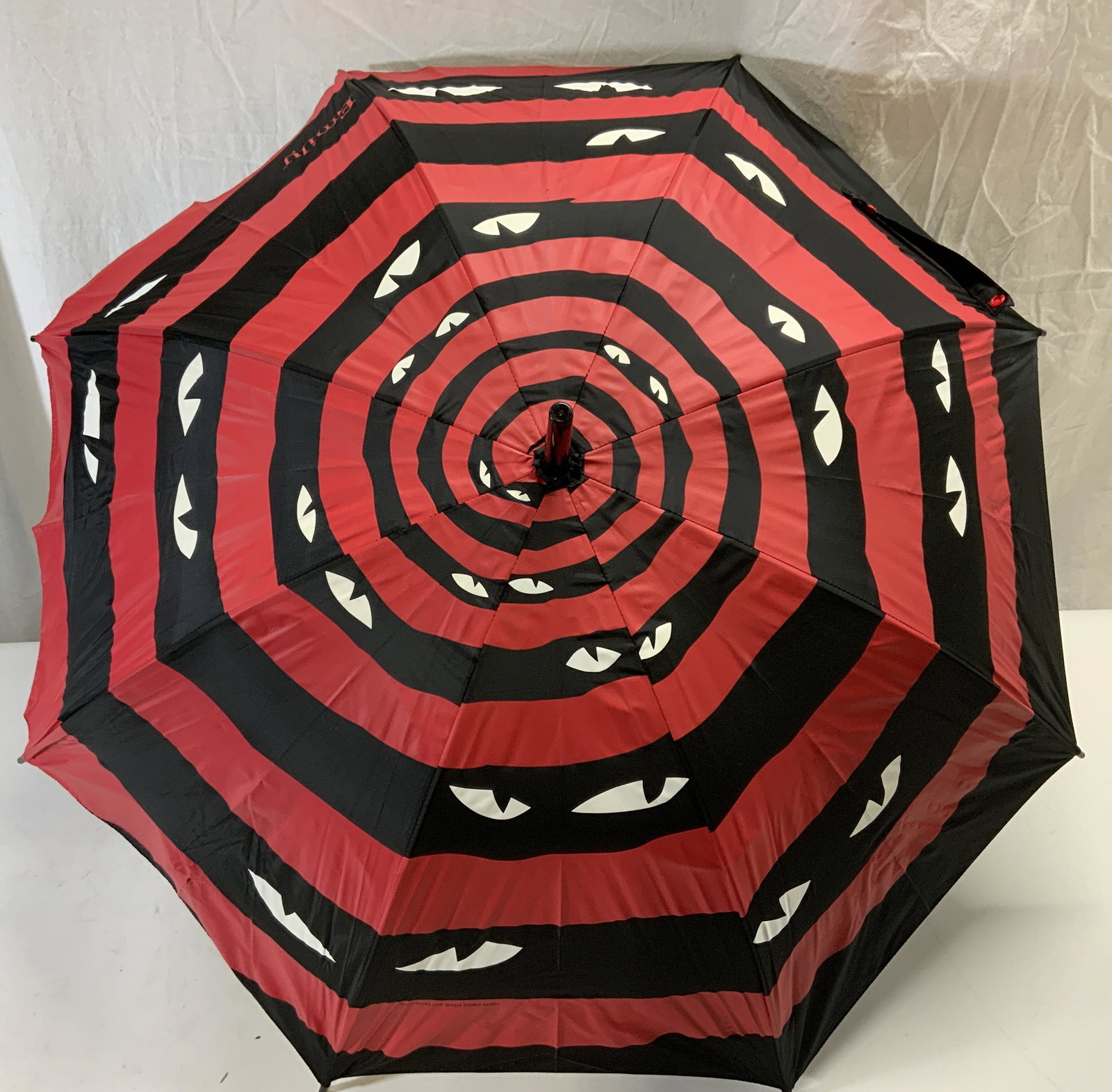 EMILY THE STRANGE Black/Red Eye Umbrella NWT: Emily the Strange umbrella in red and black with eye motif. New with tag. Measures approx. 31.5 inches long and 35.5 inches diameter. Emily the strange, Emily the strange umbrella, pop culture accesso
