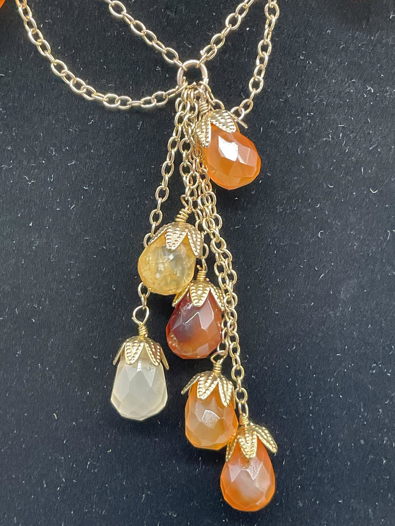ANTHROPOLOGY Natural Orange Stone Choker: Possibly carnelian stone. Tested Positive for natural stone on gem tester. Faceted gems to gold toned chain. Measures from end to end 16 inches. Adjustable length. Original retail tag to piece. Carnel