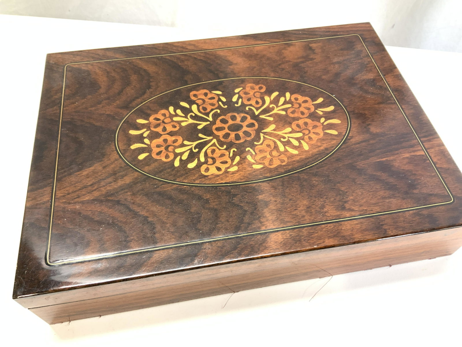 London Eather Inlaid Lacquered wood Jewelry Box: Lacquered Wood Jewelry box with inlaid wood , interior has a mirror, covered with velvet , sections for rings, earrings, chains and bracelets, . Light wear to a corner. Measures 13 x 9.5 x 2.5 in. Jew
