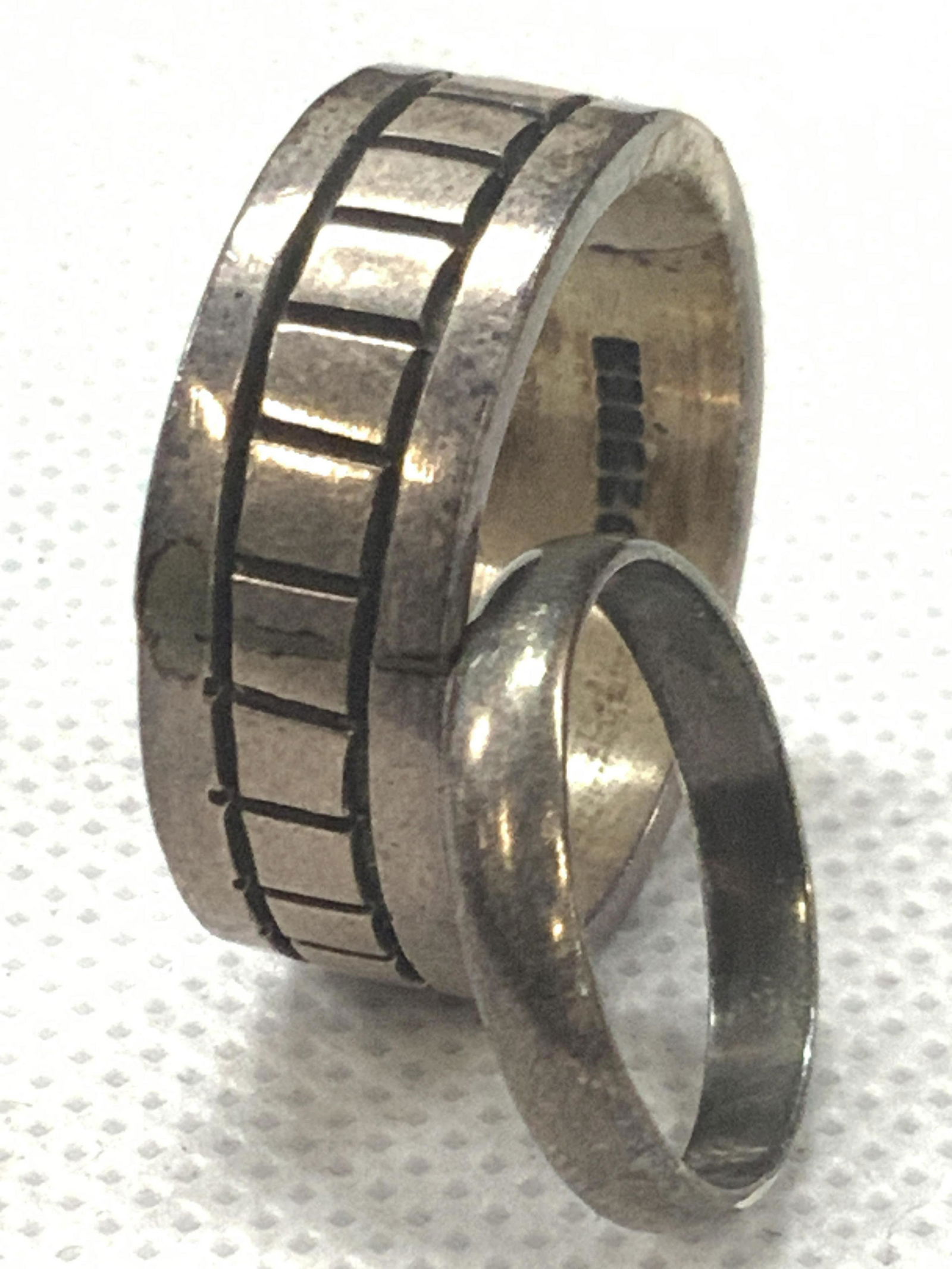 Lot2 Sterling Rings Sizes 10.75 & 5: 2 sterling silver rings, 1 sized 10.75 with vertical cut grooves in exterior, marked on interior of band 925. 1 ring with no markings, tested positive for sterling silver using Puritest metal tester,