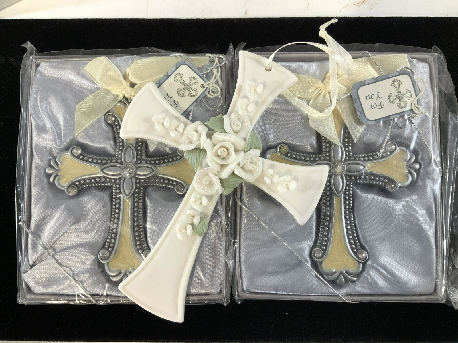 Porcelain, Enamel Crosses, NIB, 3: White porcelain cross with raised roses. Hanging ribbon attached, measures 5.5 x 4.25 in. 2 new in package cream enamel crosses with gift tag, each cross measures 4.5 x 3.5 in. and ribbon bow. Porcela