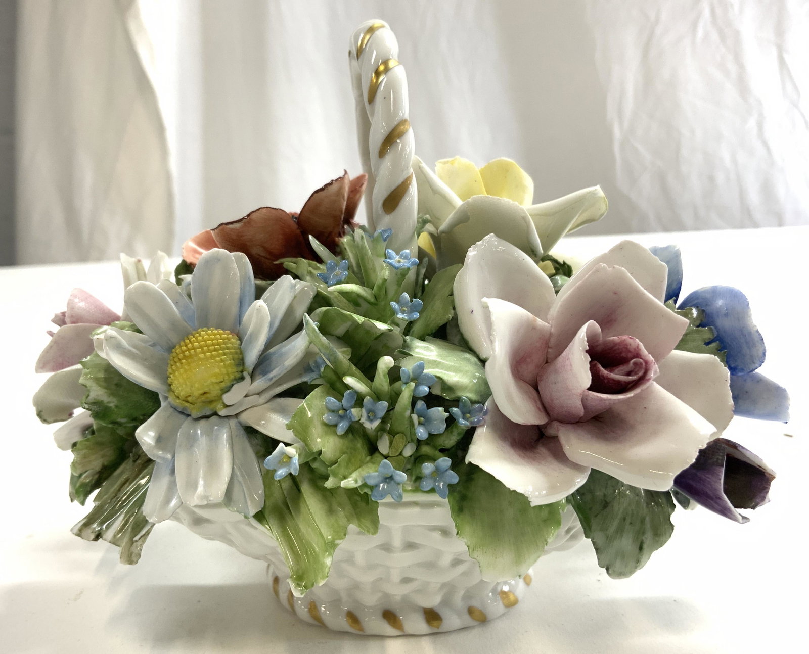 NIPPON Porcelain Flower Basket Sculpture: Underside has trademark which reads N. Piece is vintage & porcelain. Depicts a floral arrangement in a planter. Measures approx 5 inches tall 6.5 inches wide 4.5 inches deep. Nippon, Nippon porcelain,