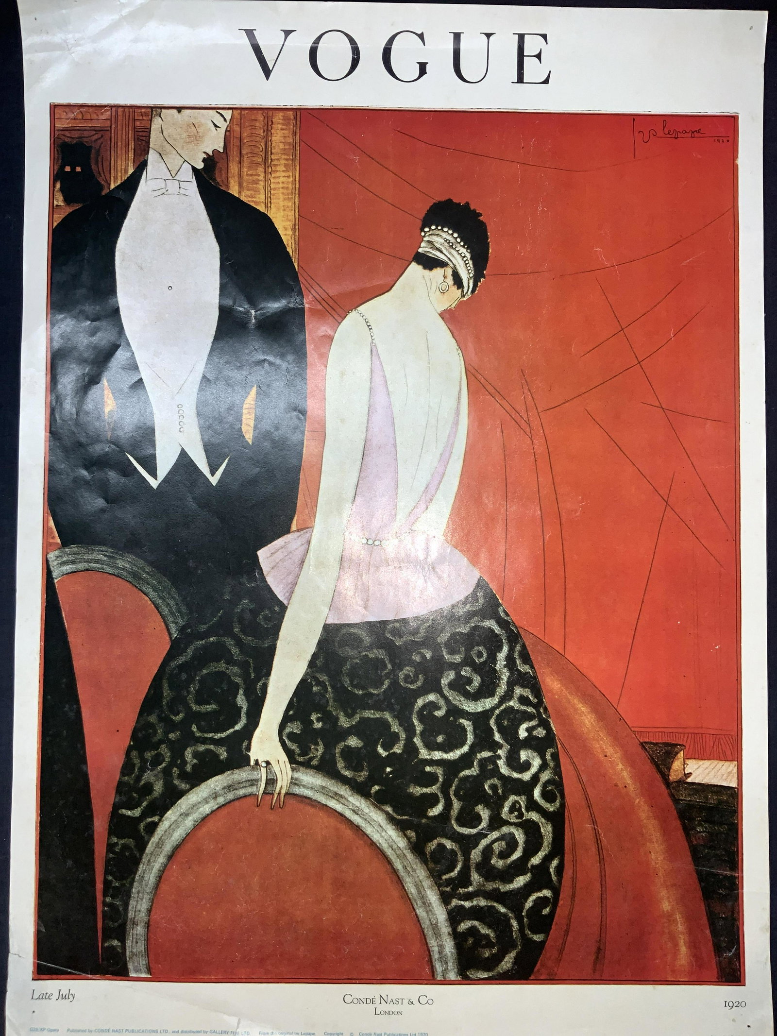 1920s VOGUE Cover Art Lithograph Lepape Opera: Vogue cover art lithograph. Marked Vogue on top. Bottom reads Conde Nast & Co, London. Late July 1920. Published 1970. Subject depicts a man and woman dressed in formal attire at an opera house. Artis