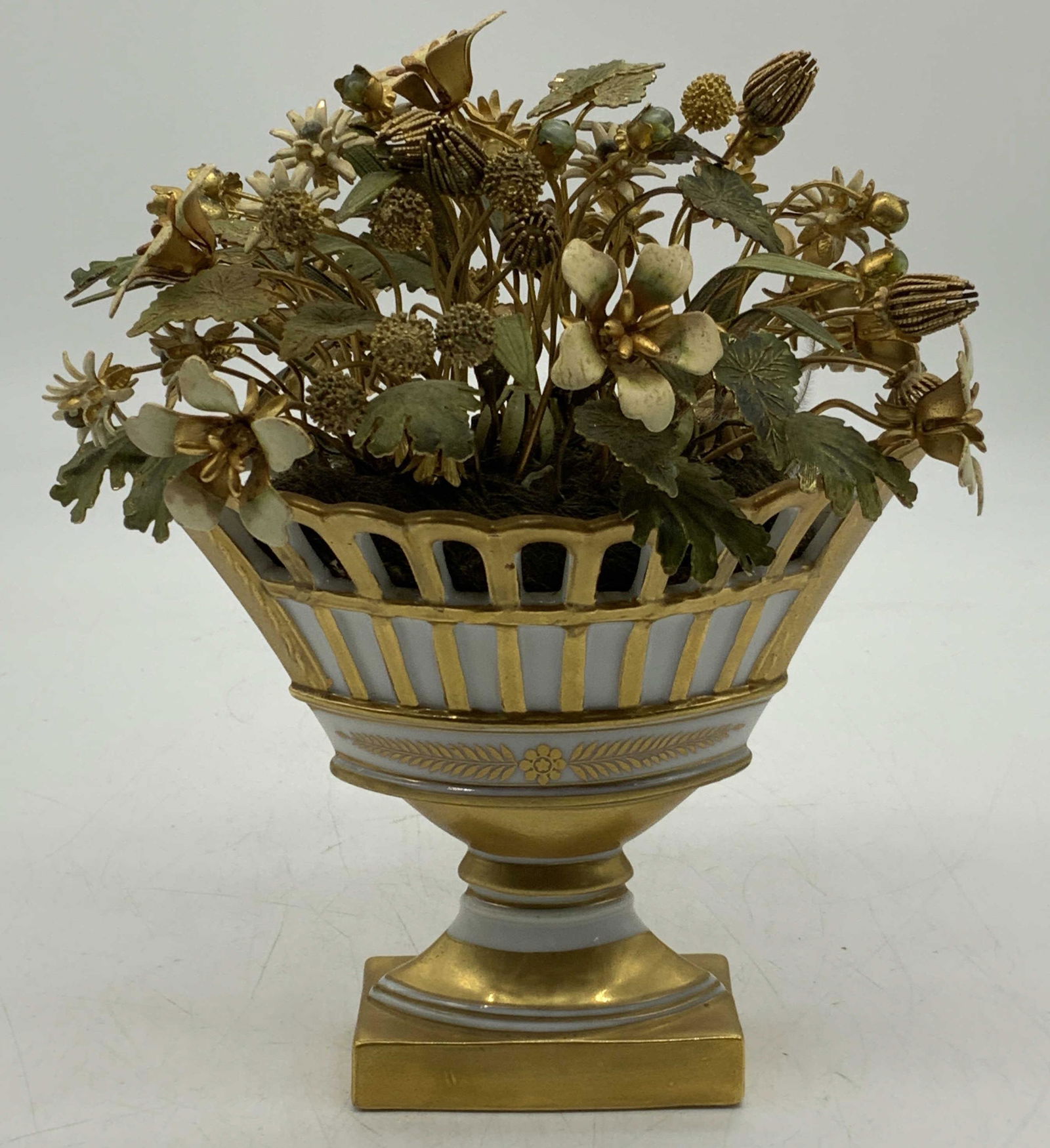 GORHAM CO Gilt Porcelain Flower Basket Display: Designed by Jane Hutchinson for The GORHAM Company gilt porcelain basket with faux brass flowers. Trademarked to underside. Measures approx. 5.75 x 4.25 x 7 inches. Surface wear consistent with exposu