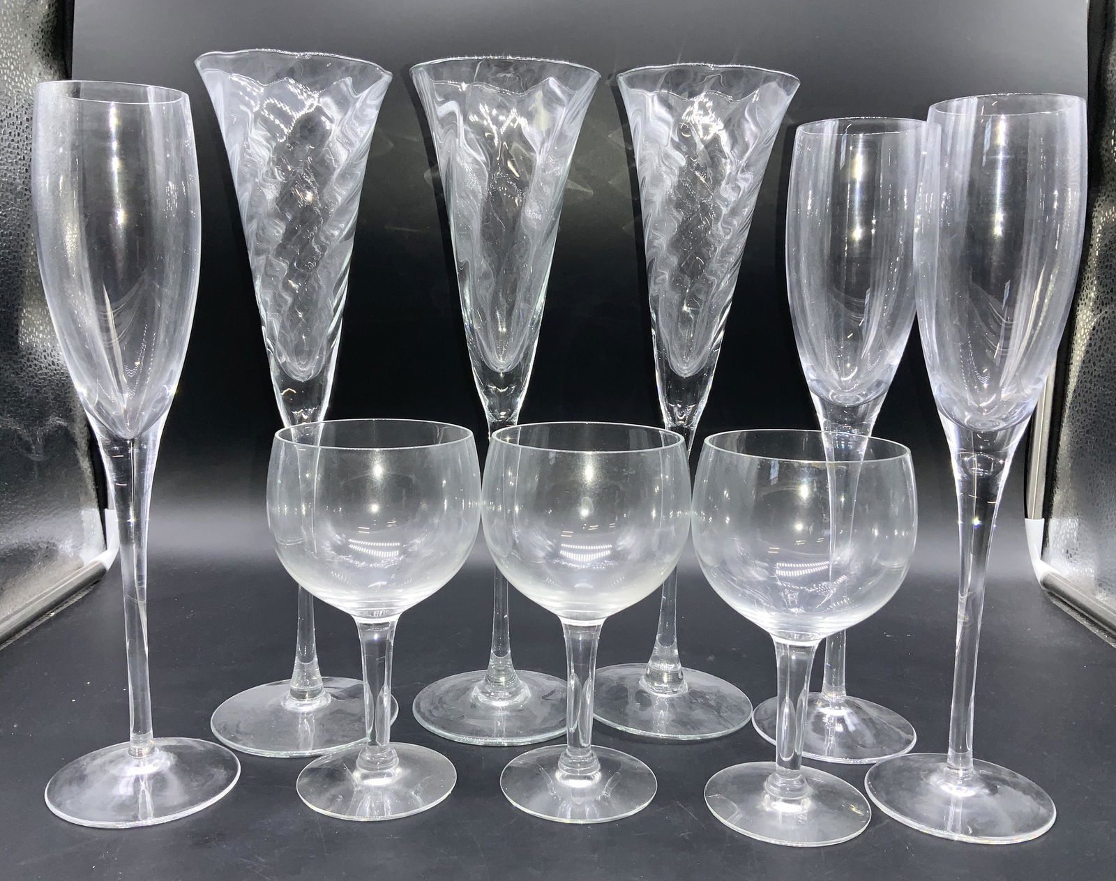 Lot9 Hand Blown Crystal Flutes, Wine glasses: 3 Trumpet champagne flutes with ripple effect, hand blown crystal, 11.5 in ht. , 3.25 in wide. 3 traditional crystal champagne flutes, 10.5 in. Tall. 3 Red wine Crystal goblets, 6 x 3.5 in. Hand forme