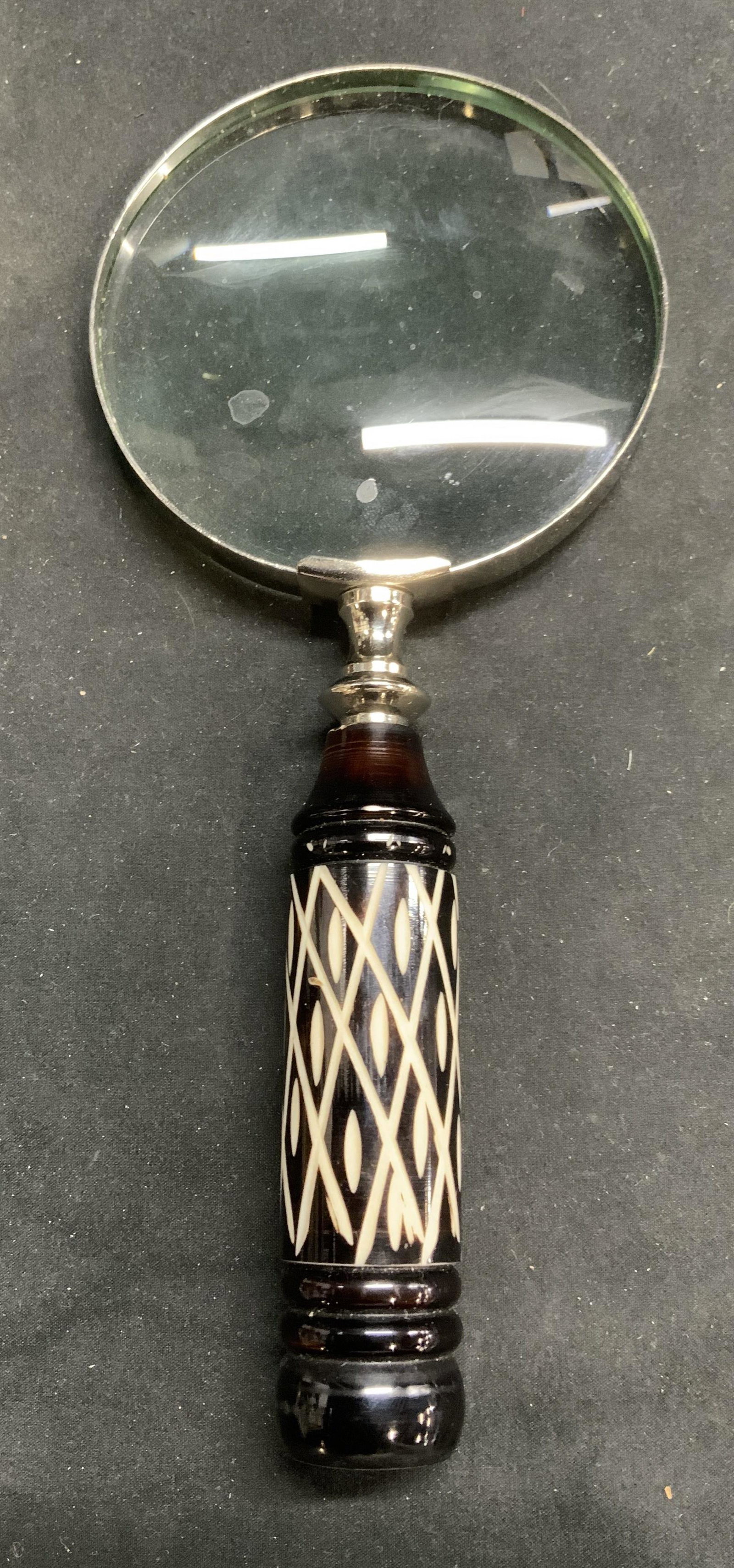 Vintage Magnifying Glass w Carved Handle: Vintage magnifying glass with carved acrylic handle. Measures approx. 4 inches wide and 9.25 inches long. some surface wear consistent with exposure. Vintage magnifying glass, magnifying glass, desk a