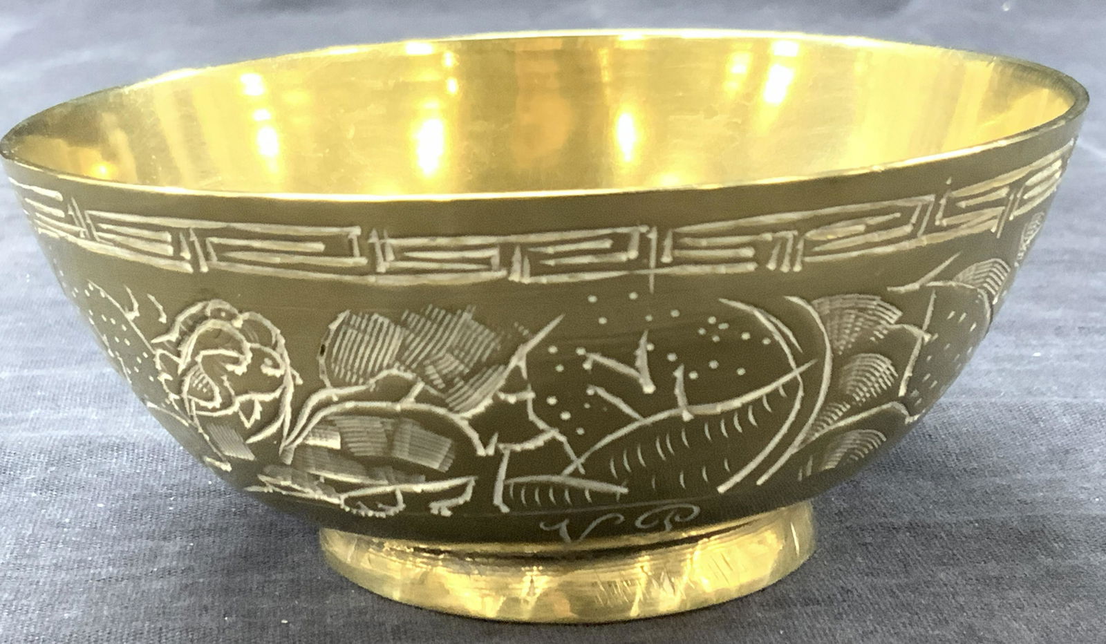 Vintage Etched Brass Bowl, 1925: Vintage brass made footed bowl with etchings on exterior with floral motifs and animals such as turtles. Marked on exterior VS 1925 Approximately 2 inches tall and 4.5 inch diameter Minor wearing to b