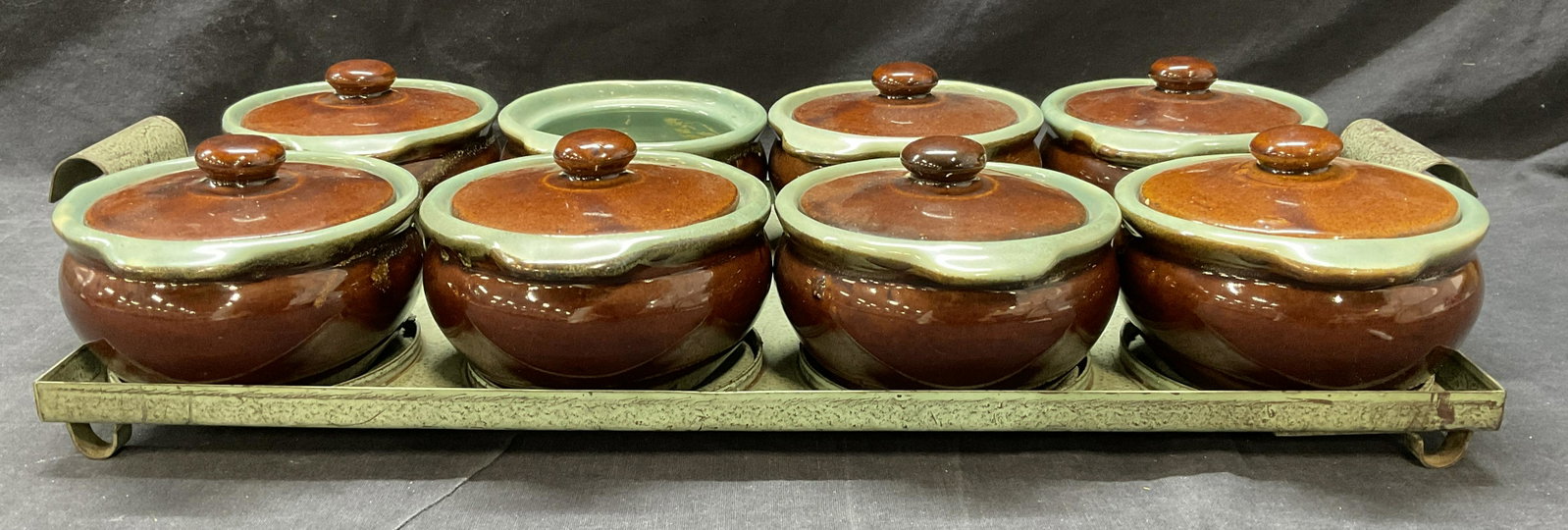 Stoneware Casserole Pots W Tray: No hallmark or signatures observed. Tray measures approx 20.25 x 9 1/8 inches. Minimal chipping to some edges on inner lids. One lid missing. Surface wear to pieces are consistent with prior use and a