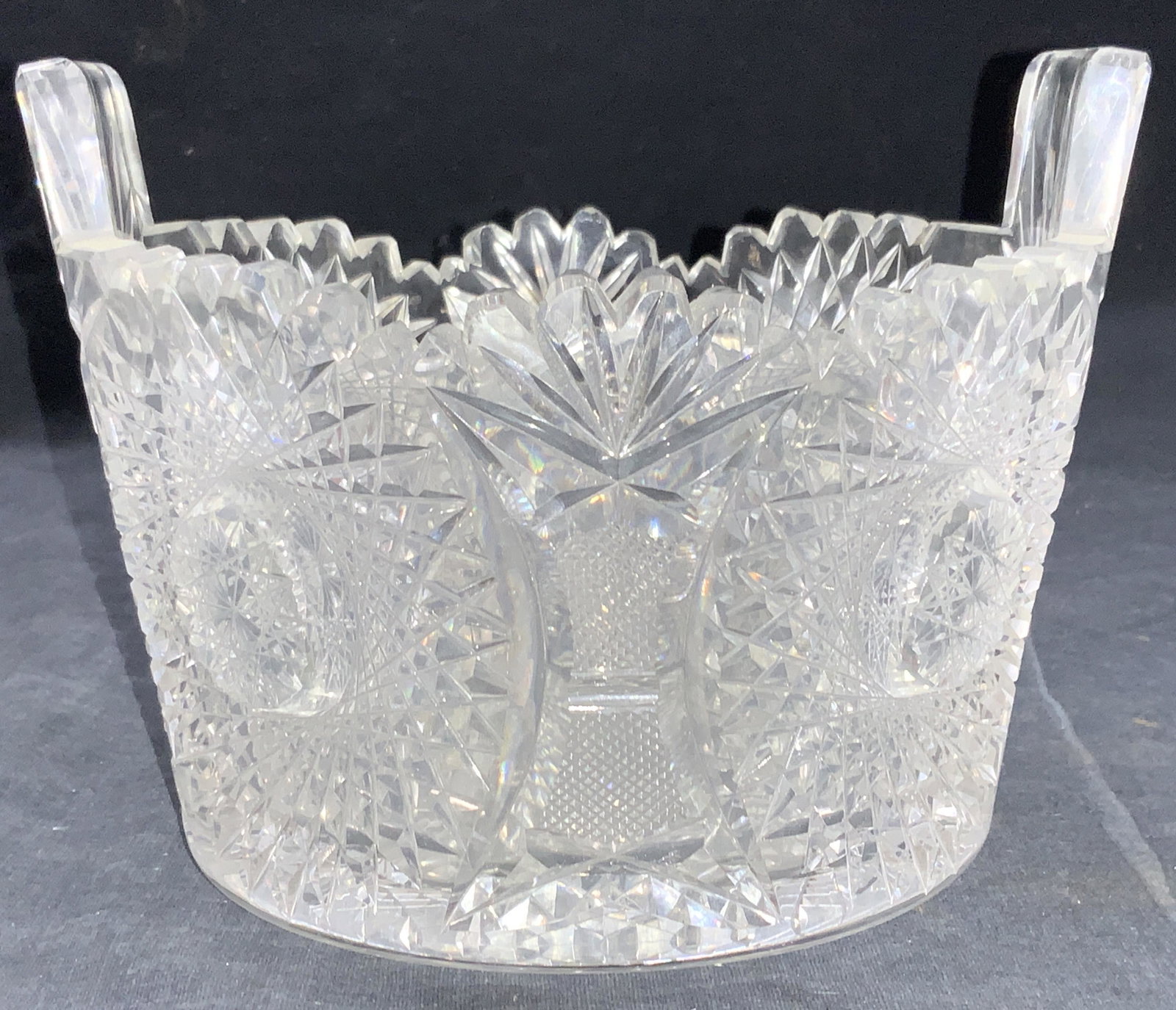 Hand Cut Clear Glass Vessel: Hand cut glass vessel with saw tooth edges and hand cut spiral patterns with Star burst patterns. Approximately 5 inches tall and 6.5 inch diameter. Minor wearing due to age and use. Hand cut glasswar