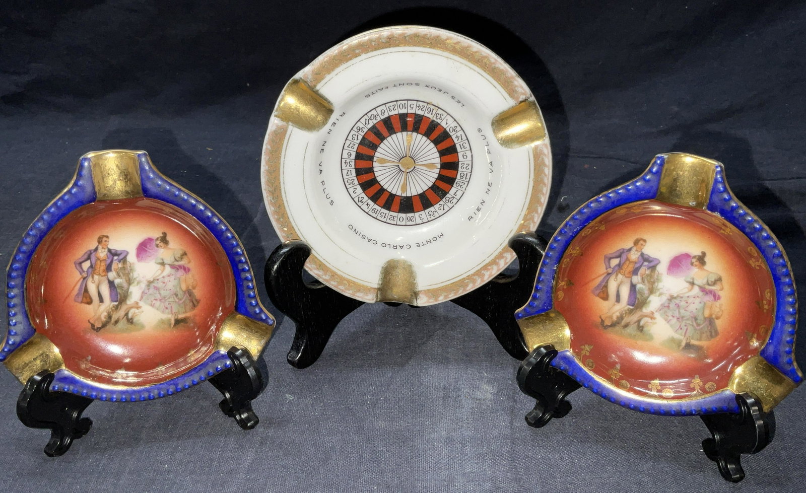 Lot 3 Hand Painted Ash Trays, Limoges & More: Lot 3 Hand Painted Ash Trays. Porcelain ware, w gilt detailing to surface. Slight surface wear to pieces. Largest piece labeled Limoges France, measures approx 4 x 0.75 inches. Smaller ash trays are l