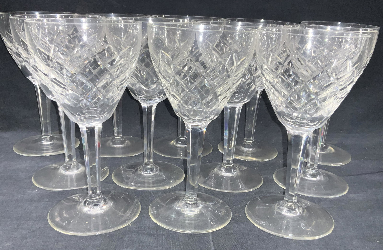 Set 12 Maastricht Crystal Stemware/ Wine Glasses: Set of 12 cut crystal wine glass stemwares. Marked Maastricht on undersides, Cut with diamond shapes on exterior with faceted stems and solid bases. Approximately 7.25 inches tall and 3.75 inch diamet