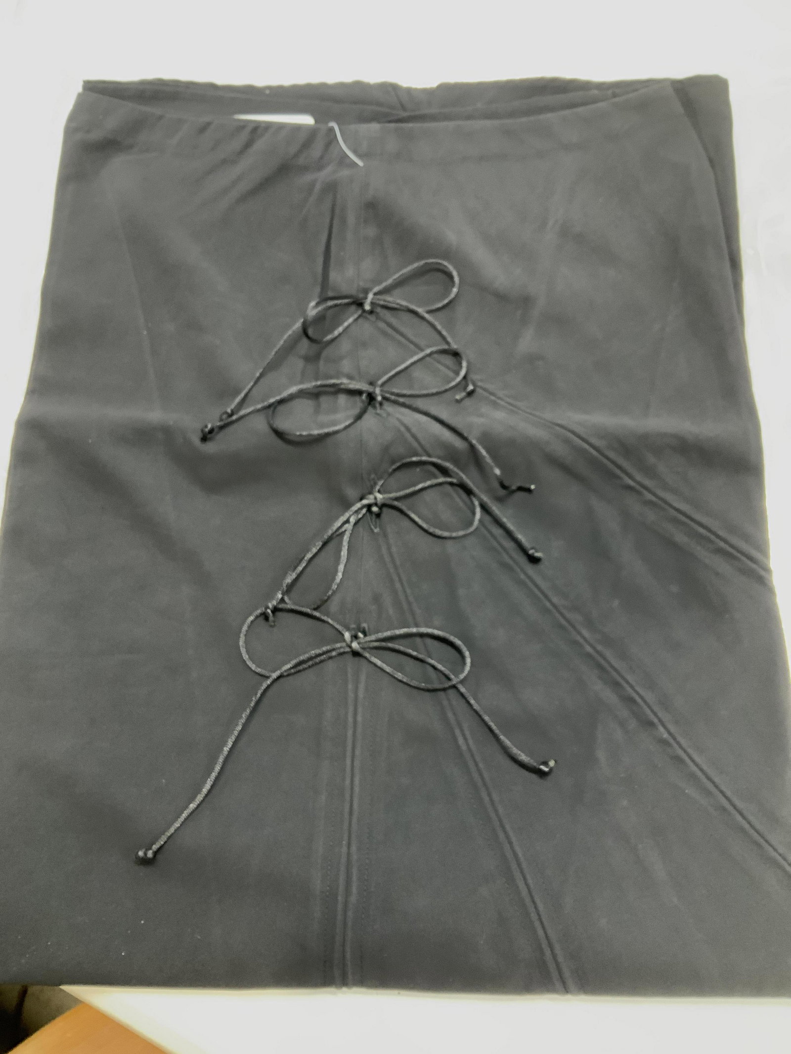 ILLIG sz XS Long Black Skirt, NIP: Polyester skirt that feels like faux suede, size XS, new with tag and in original plastic packaging, Decorative accent tie strings on the side of skirt, 41 in. L zipper backside. Skirt, Designer ILLIG