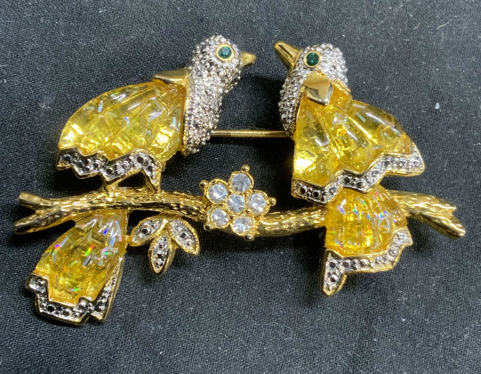 Gold Tone Crystal Bird Brooch: Gold tone bird brooch with yellow, green, and colorless crystal decoration. Hinge pin to underside. Measures approx. 2.25 x 1.25 inches. In good condition. Property of Palm Beach, Florida estate. Esta
