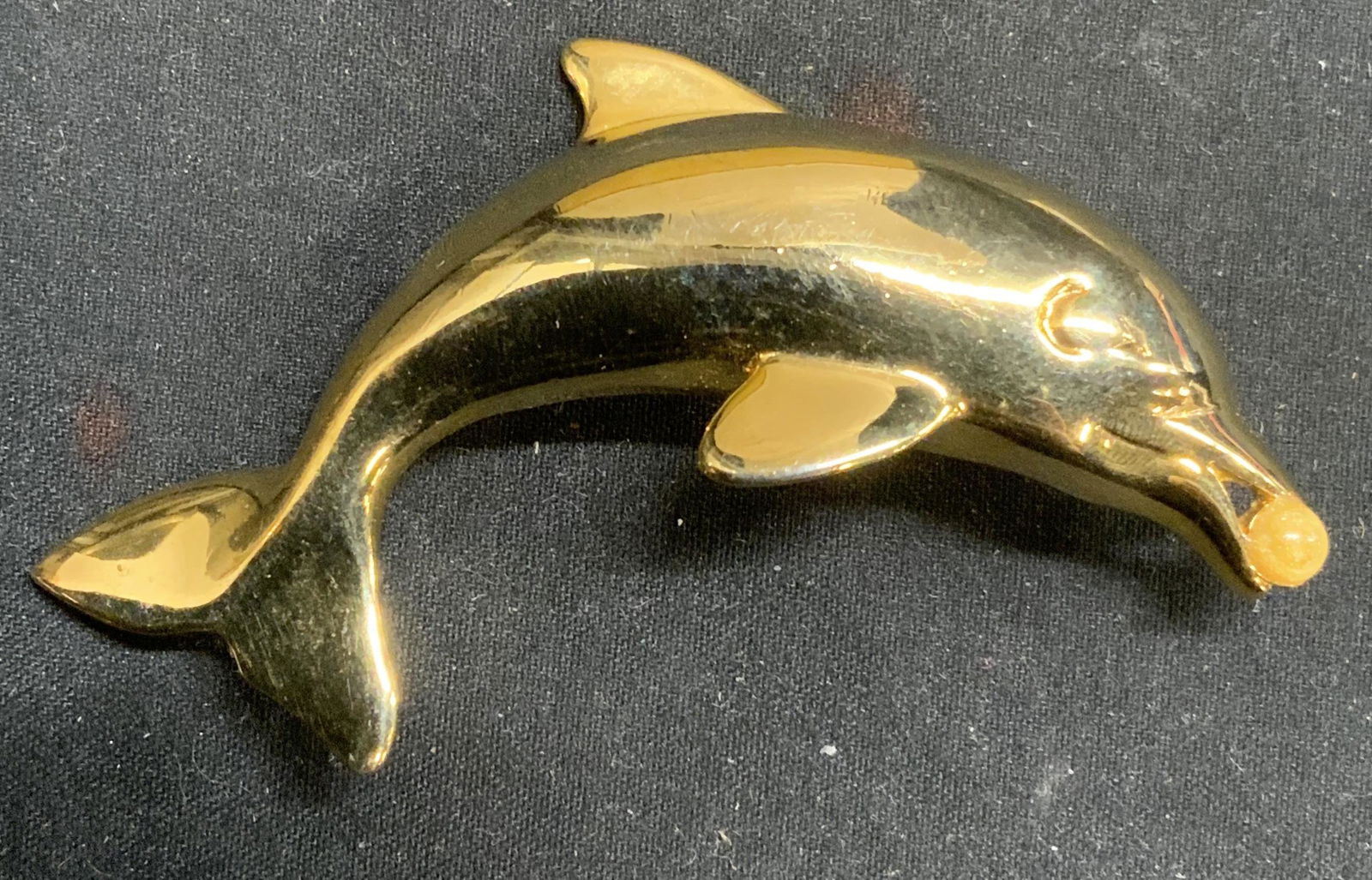 Gold Tone Dolphin Brooch, Jewelry: Gold tone dolphin brooch with gold toned Cabochon decoration. Hinge pin to underside. Measures approx. 2.5 x 1.5 inches. In good condition. Estate jewelry, costume jewelry, Cocktail jewelry, fashion j