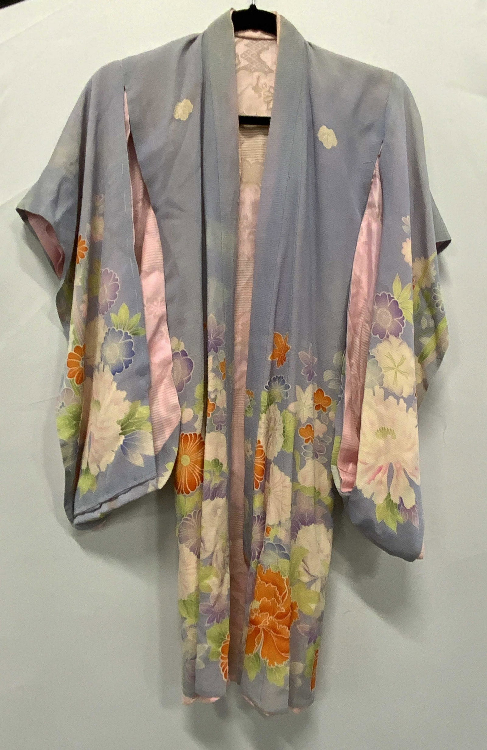 Blue Multi Color Floral Print Robe: Blue multi color floral print robe with butterfly sleeves. Some wear to fabric consistent with exposure, blemishes and pulling observed. Material feels like synthetic. Measures approx. 12.5 inches acr