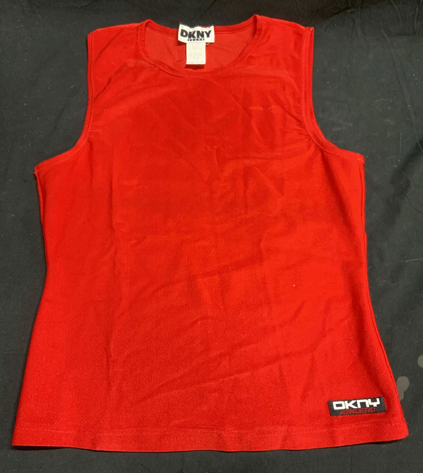 DKNY Red Sleeveless Athletic Top: DKNY red sleeveless athletic top. Size M. Nylon and spandex blend. Gently worn, some pulling and small blemish observed. DKNY, DKNY athletic top, DKNY top, ladies designer athletic wear, ladies design