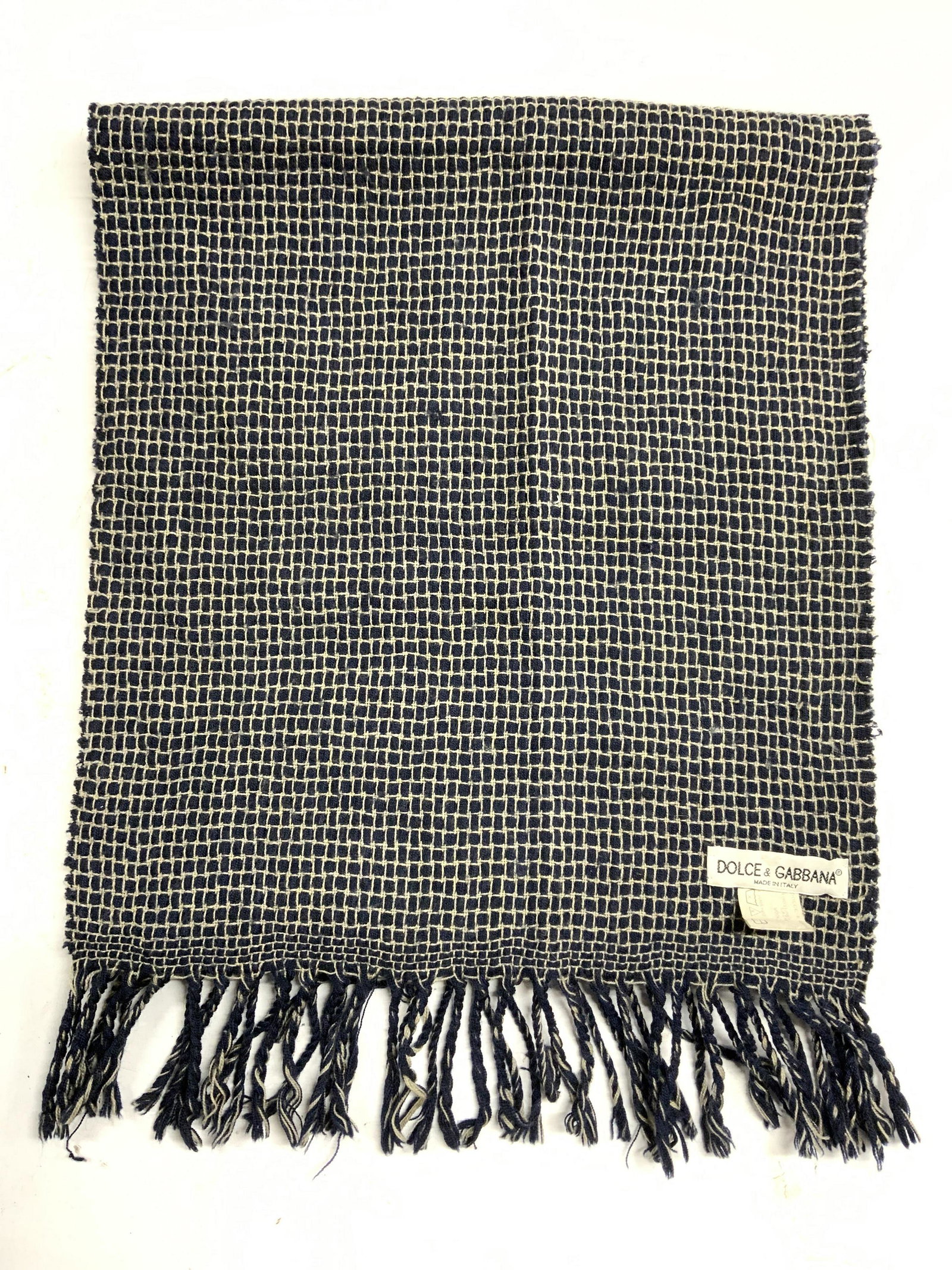 DOLCE & GABBANA Blue Windowpane Wool Scarf: Dolce and GABBANA blue wool scarf with windowpane embroidery. Designer label to fabric. Measures approx. 60 inches long. Wear to fabric consistent with exposure, pulling and blemishes observed. Dolce 